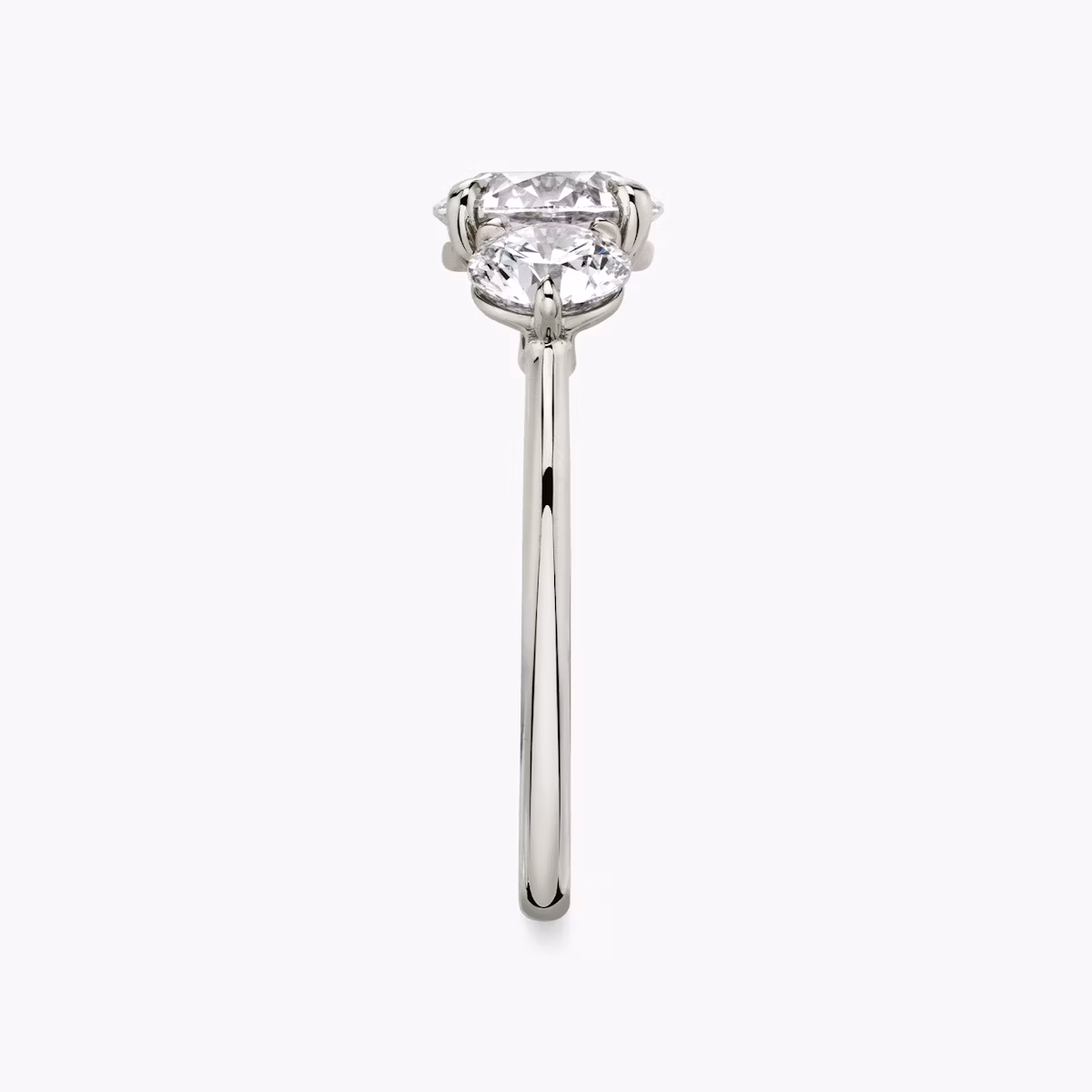 The Three Stone | Round Brilliant | Platinum | bandAccent: Plain | caratWeight: other | sideStoneCarat: 0.50ct | sideStoneShape: Round Brilliant | diamondOrientation: vertical