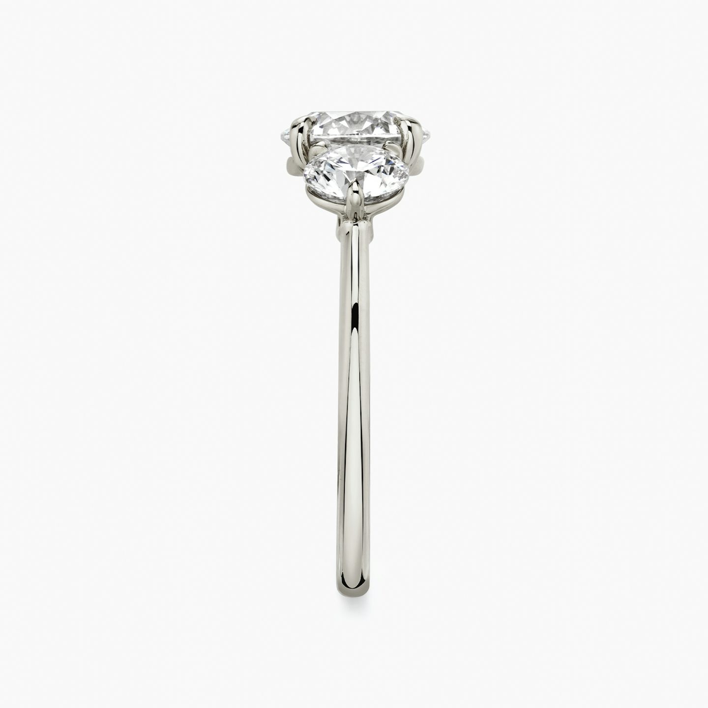 The Three Stone | Round Brilliant | Platinum | bandAccent: Plain | caratWeight: other | sideStoneCarat: 0.50ct | sideStoneShape: Round Brilliant | diamondOrientation: vertical