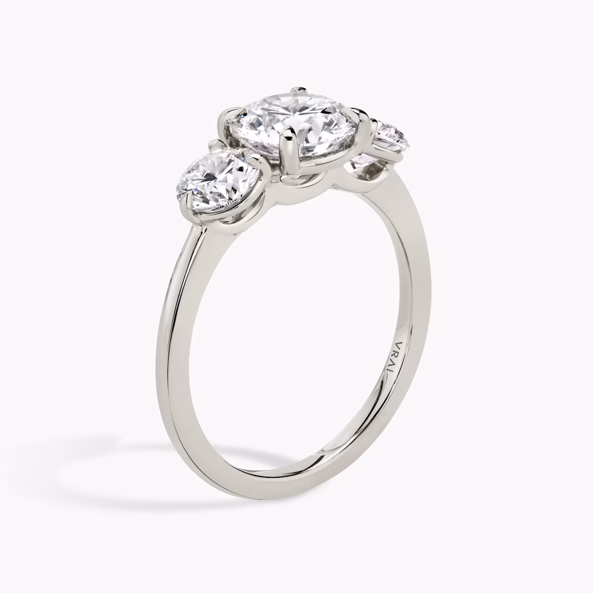 The Three Stone | Round Brilliant | Platinum | bandAccent: Plain | caratWeight: other | sideStoneCarat: 0.50ct | sideStoneShape: Round Brilliant | diamondOrientation: vertical