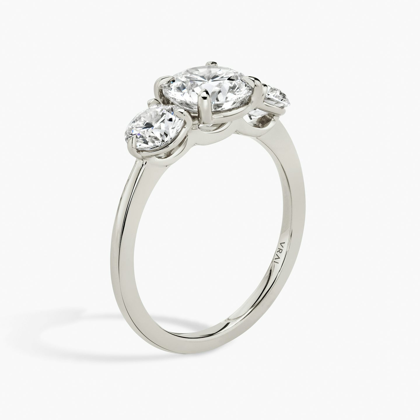 The Three Stone | Round Brilliant | Platinum | bandAccent: Plain | caratWeight: other | sideStoneCarat: 0.50ct | sideStoneShape: Round Brilliant | diamondOrientation: vertical