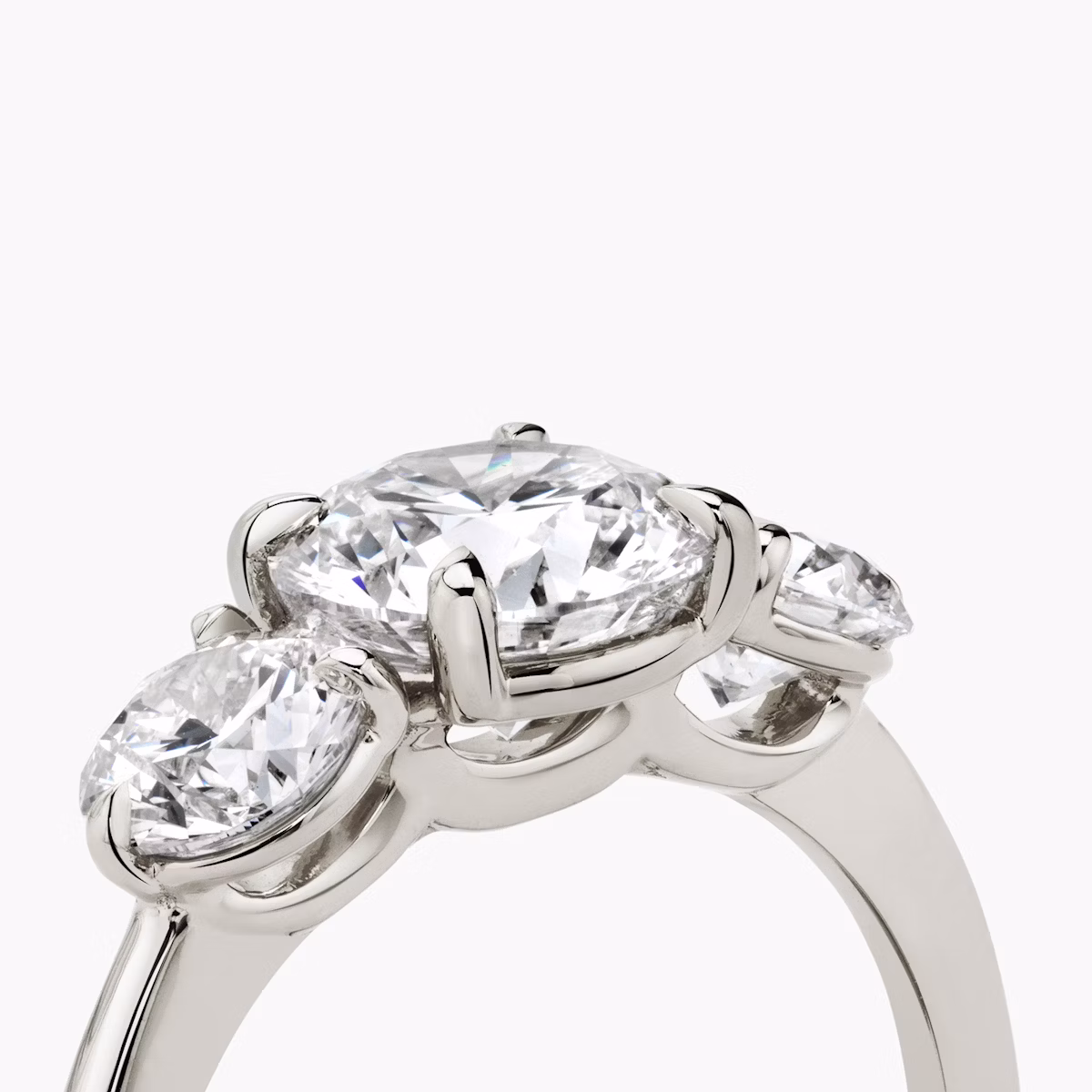 The Three Stone | Round Brilliant | Platinum | bandAccent: Plain | caratWeight: other | sideStoneCarat: 0.50ct | sideStoneShape: Round Brilliant | diamondOrientation: vertical