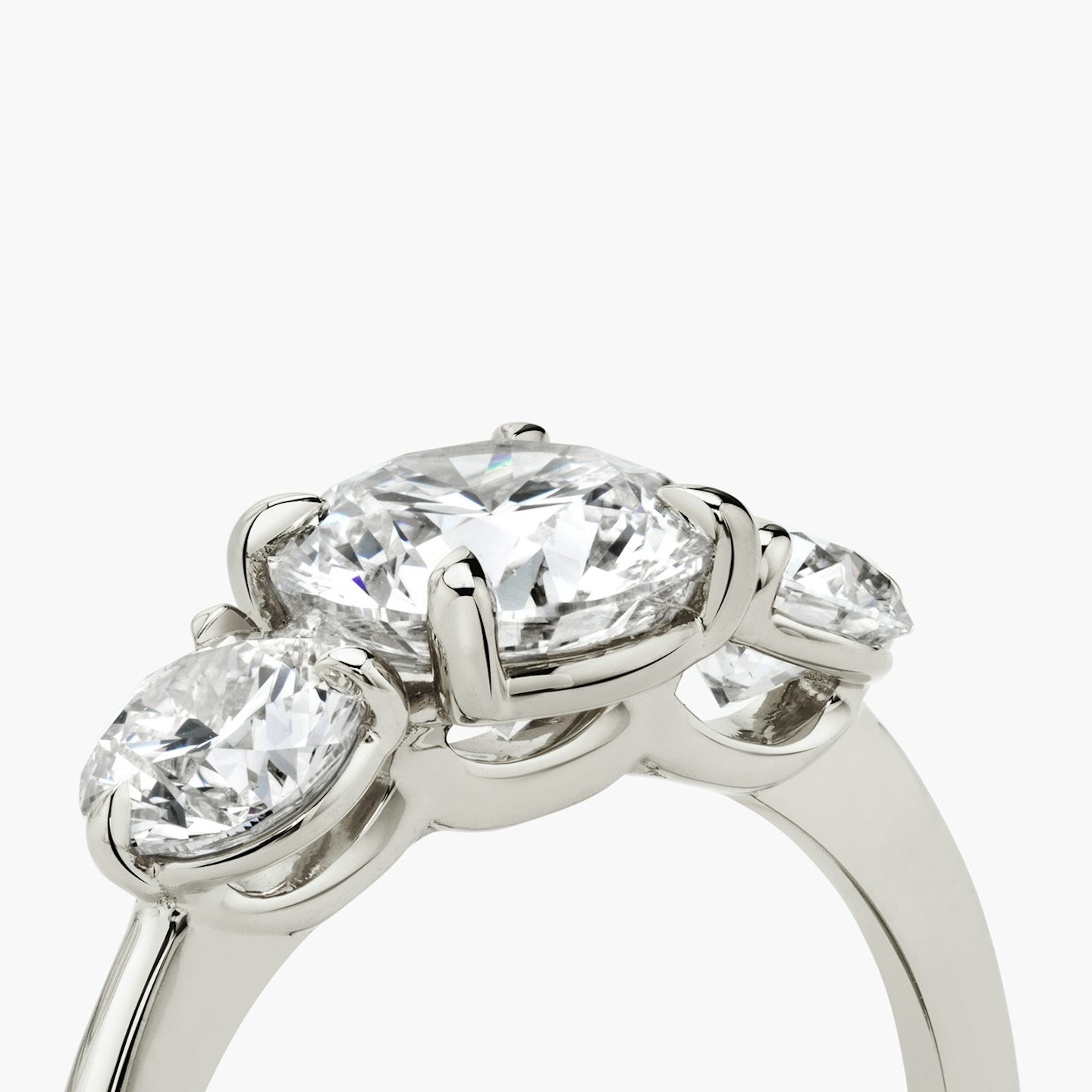 The Three Stone | Round Brilliant | Platinum | bandAccent: Plain | caratWeight: other | sideStoneCarat: 0.50ct | sideStoneShape: Round Brilliant | diamondOrientation: vertical