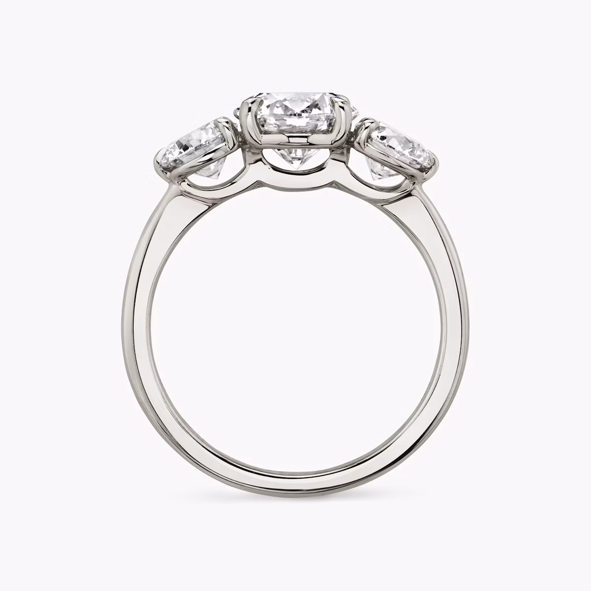 The Three Stone | Round Brilliant | Platinum | bandAccent: Plain | caratWeight: other | sideStoneCarat: 0.50ct | sideStoneShape: Round Brilliant | diamondOrientation: vertical