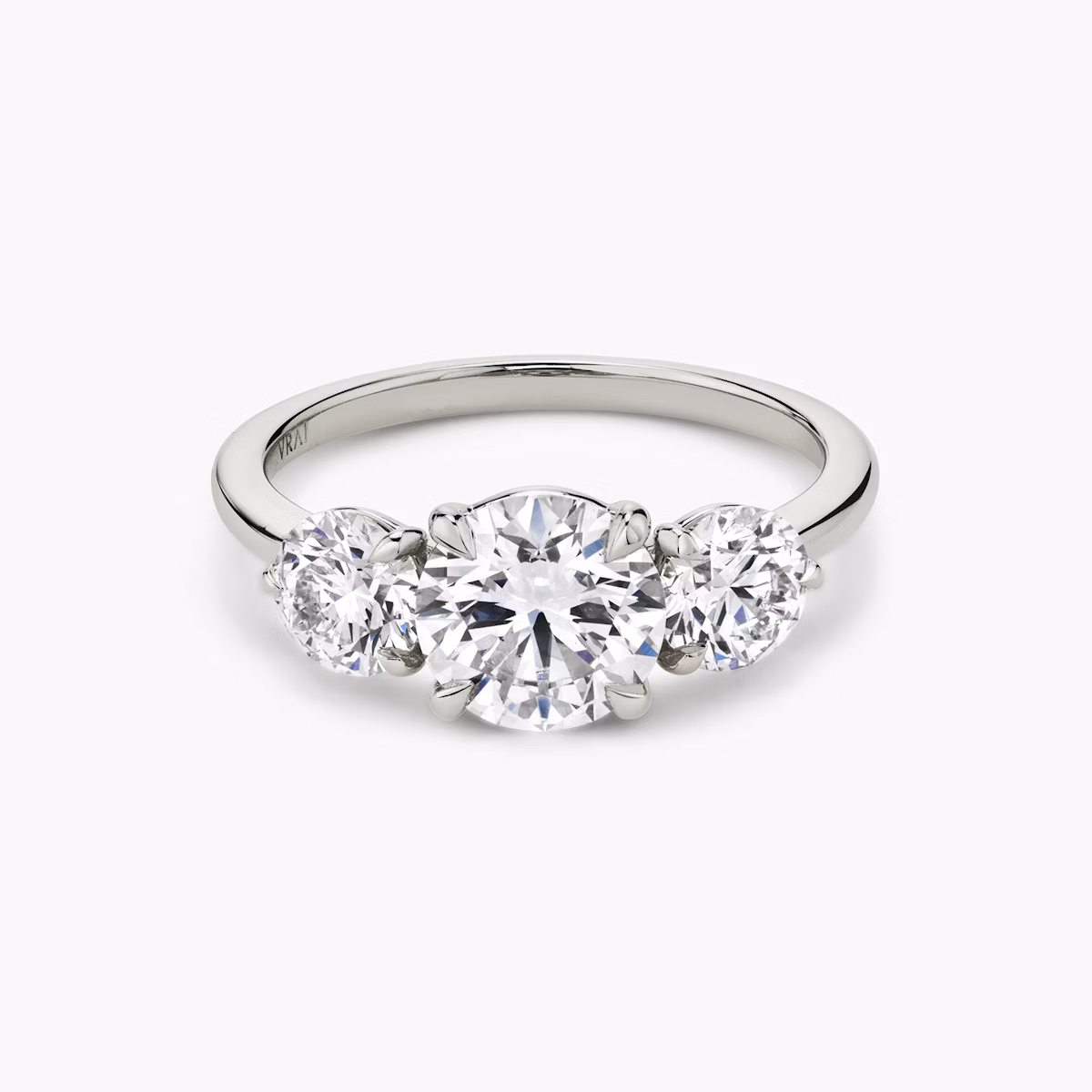 The Three Stone | Round Brilliant | Platinum | bandAccent: Plain | caratWeight: other | sideStoneCarat: 0.50ct | sideStoneShape: Round Brilliant | diamondOrientation: vertical