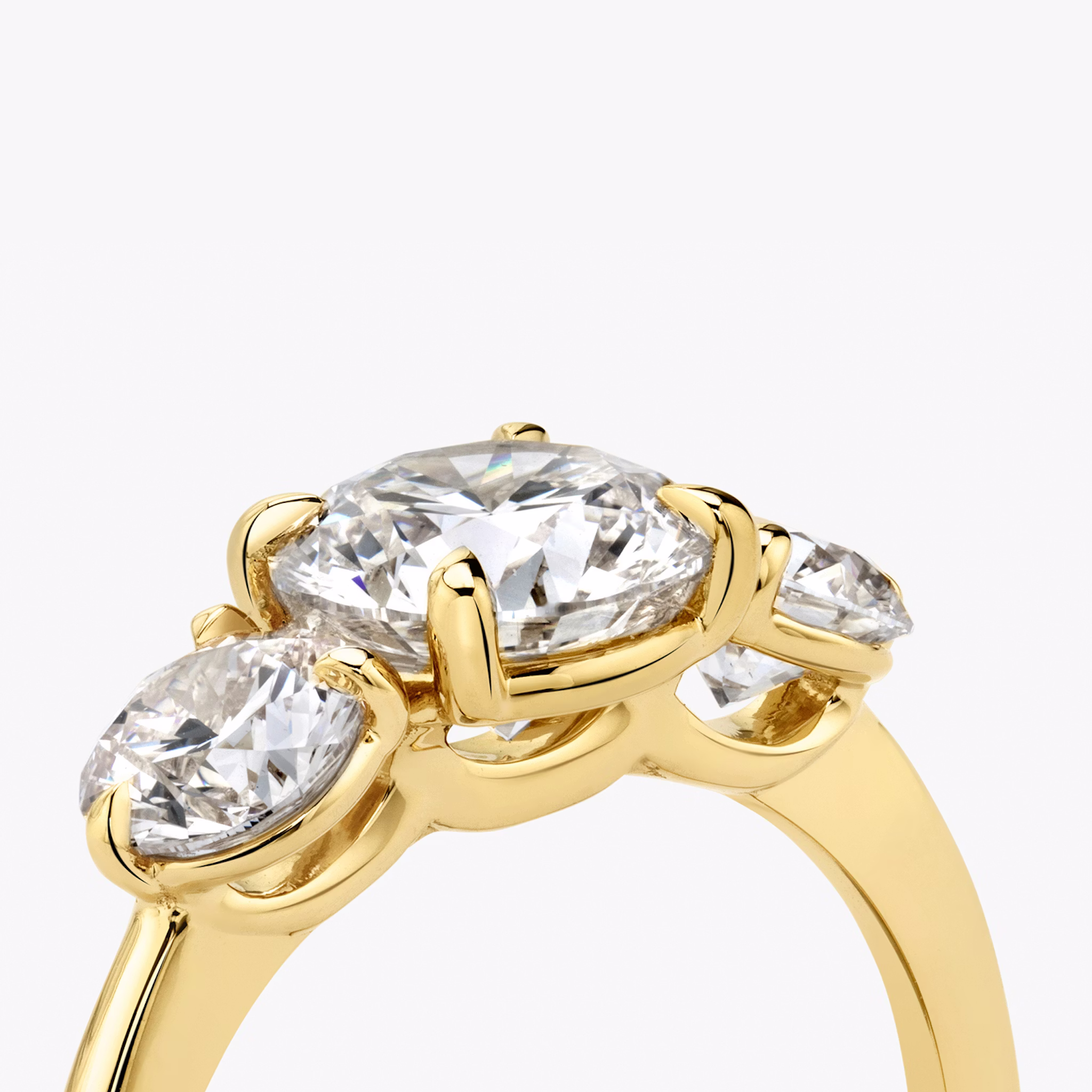 The Three Stone | Round Brilliant | 18k | Yellow Gold | bandAccent: Plain | caratWeight: other | sideStoneCarat: 0.50ct | sideStoneShape: Round Brilliant | diamondOrientation: vertical