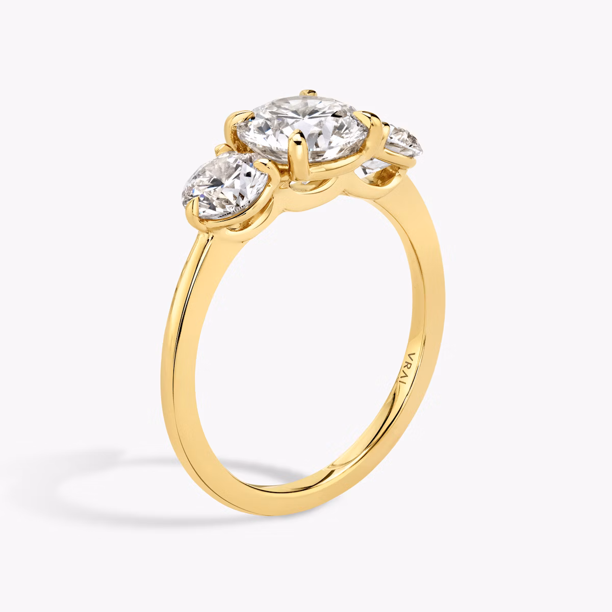 The Three Stone | Round Brilliant | 18k | Yellow Gold | bandAccent: Plain | caratWeight: other | sideStoneCarat: 0.50ct | sideStoneShape: Round Brilliant | diamondOrientation: vertical