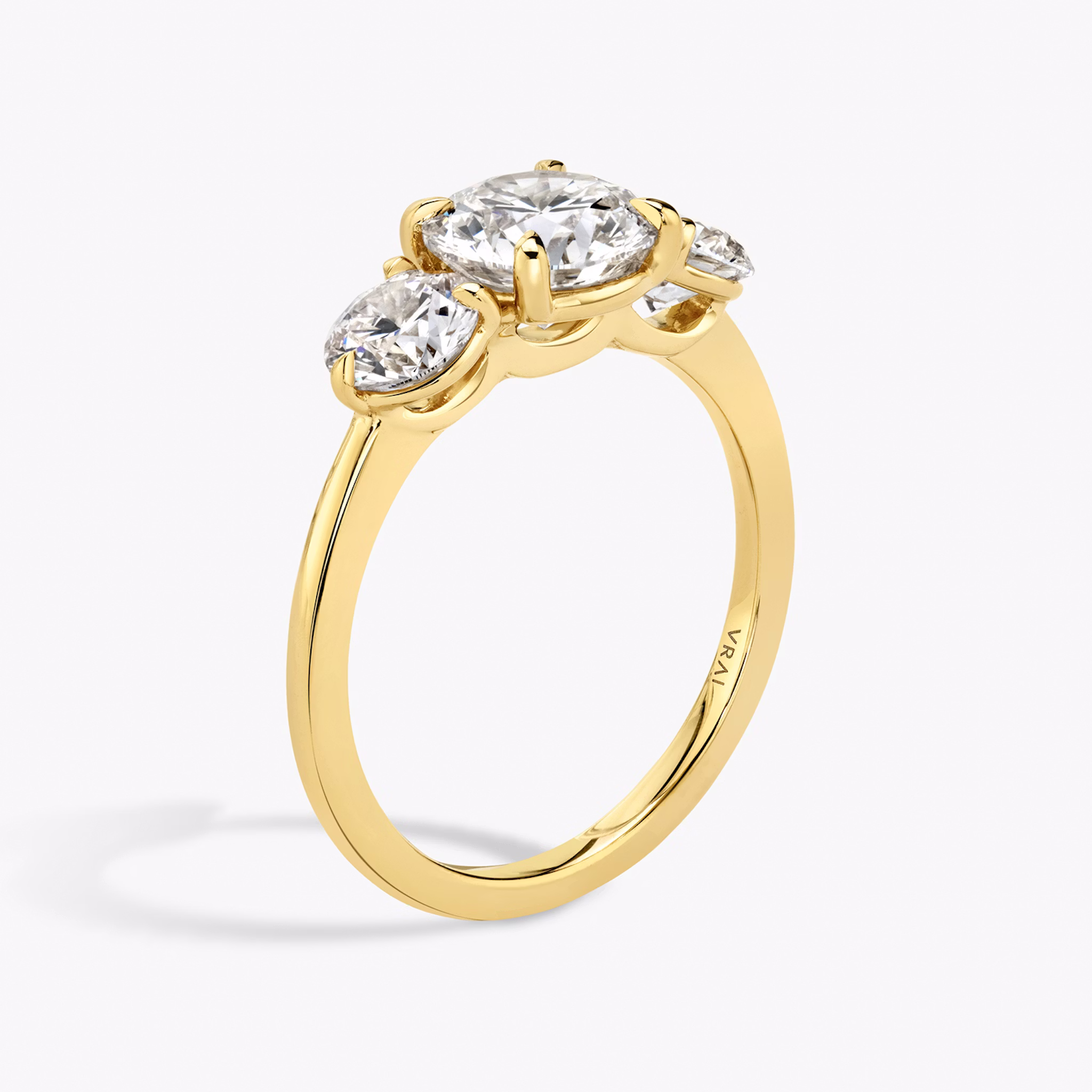 The Three Stone | Round Brilliant | 18k | Yellow Gold | bandAccent: Plain | caratWeight: other | sideStoneCarat: 0.50ct | sideStoneShape: Round Brilliant | diamondOrientation: vertical