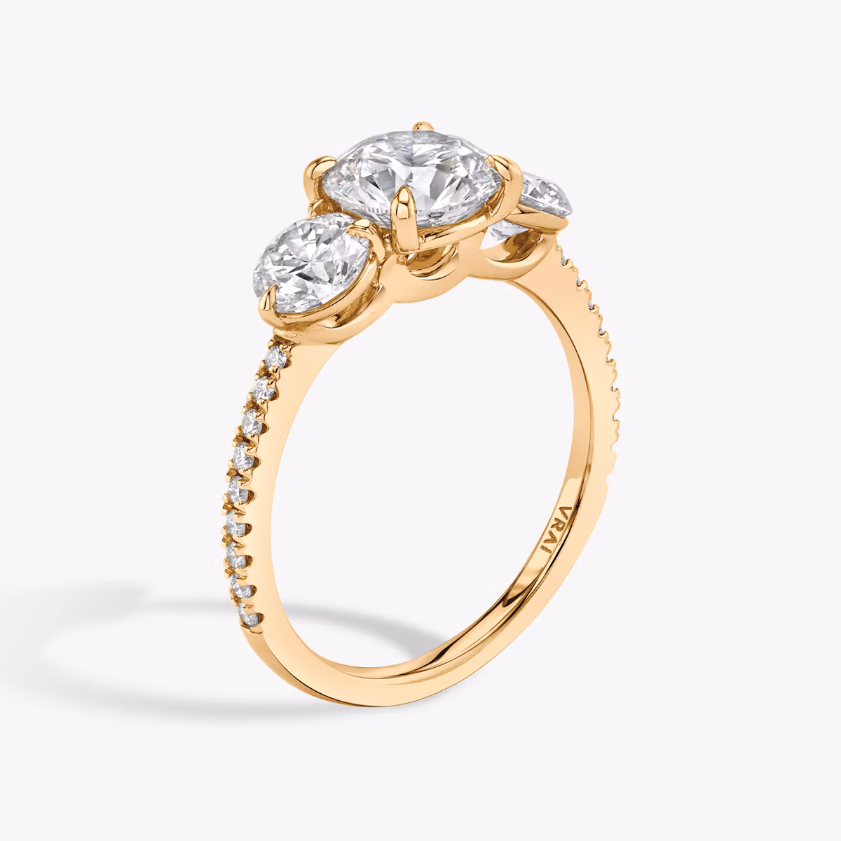 The Three Stone | Round Brilliant | 14k | Rose Gold | bandAccent: Pavé | caratWeight: other | sideStoneCarat: 0.50ct | sideStoneShape: Round Brilliant | diamondOrientation: vertical
