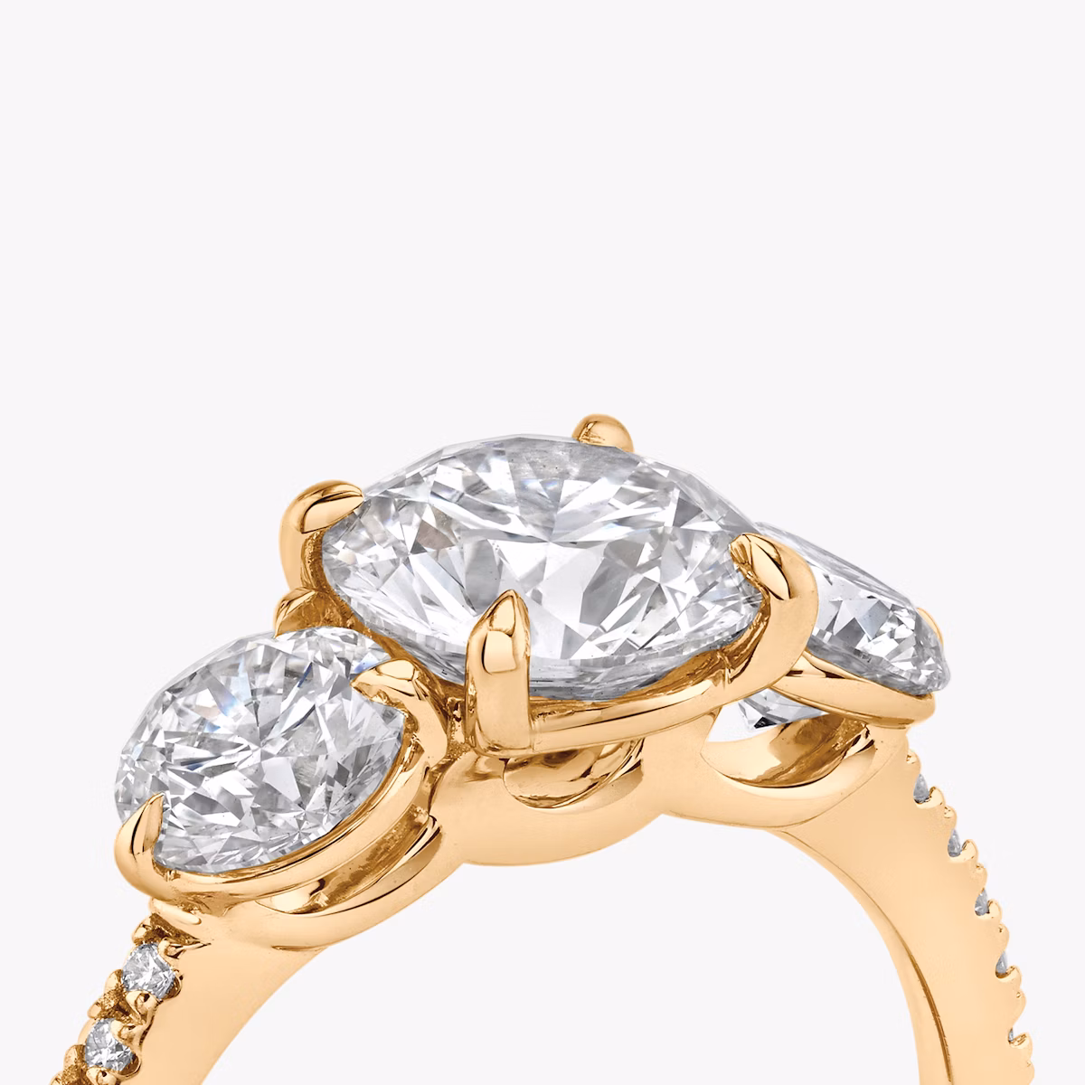The Three Stone | Round Brilliant | 14k | Rose Gold | bandAccent: Pavé | caratWeight: other | sideStoneCarat: 0.50ct | sideStoneShape: Round Brilliant | diamondOrientation: vertical