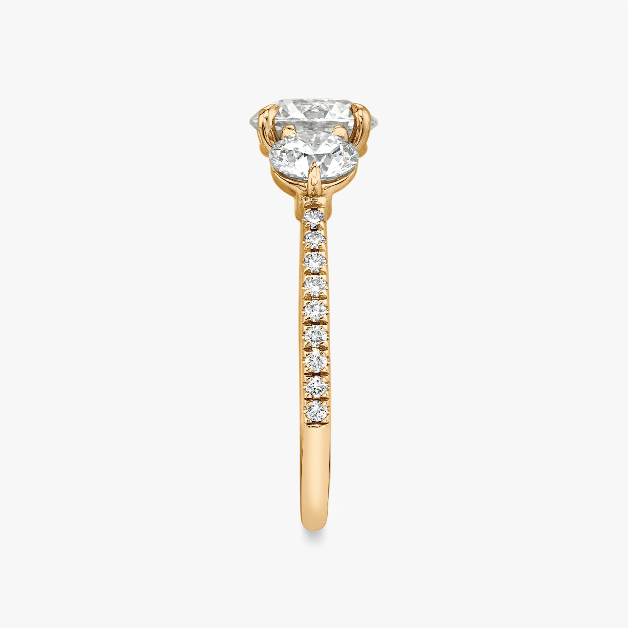 The Three Stone | Round Brilliant | 14k | Rose Gold | bandAccent: Pavé | caratWeight: other | sideStoneCarat: 0.50ct | sideStoneShape: Round Brilliant | diamondOrientation: vertical