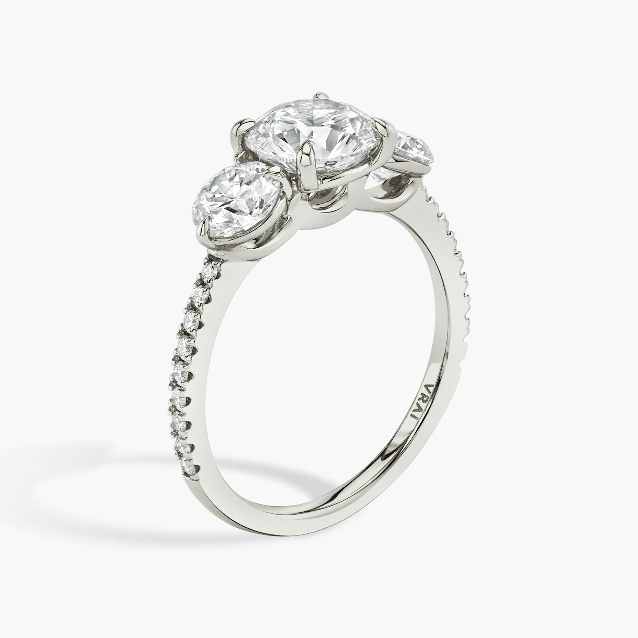 The Three Stone | Round Brilliant | 18k | White Gold | bandAccent: Pavé | caratWeight: other | sideStoneCarat: 0.50ct | sideStoneShape: Round Brilliant | diamondOrientation: vertical