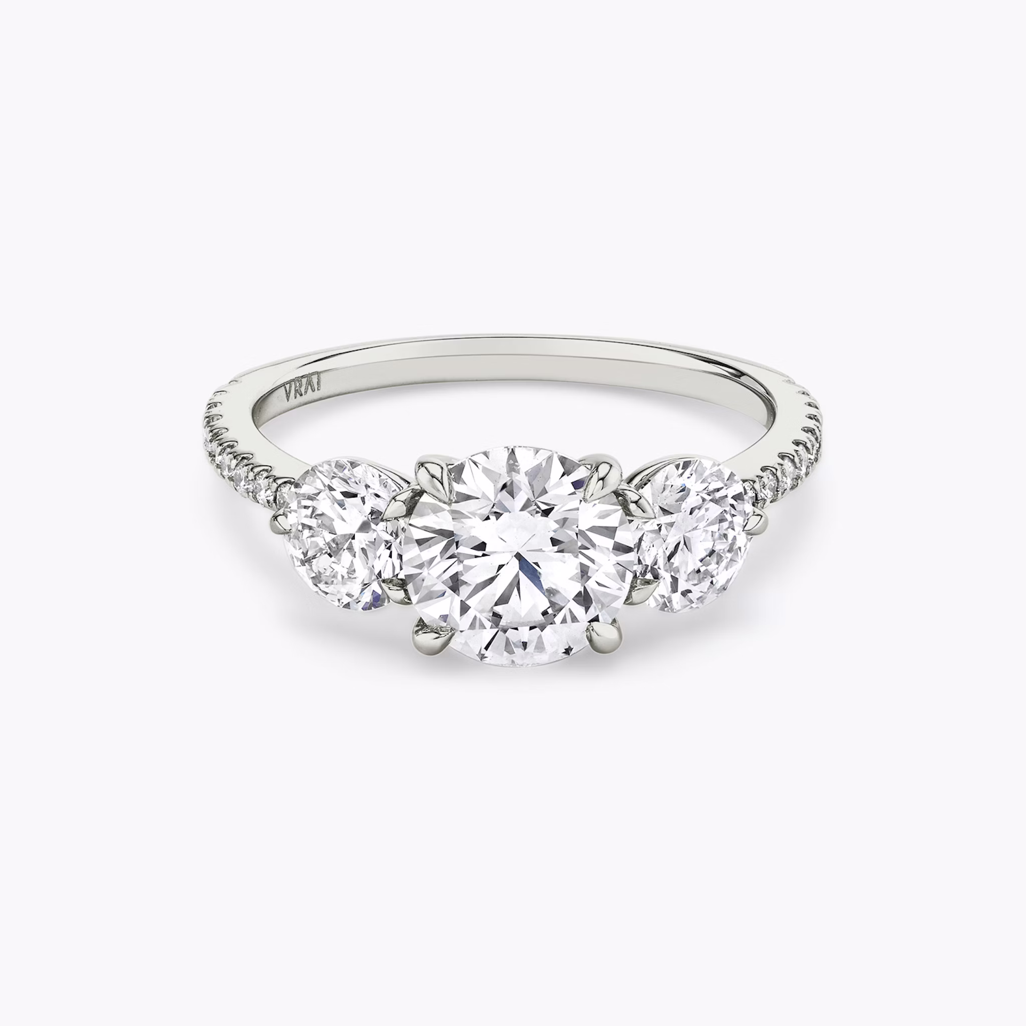The Three Stone | Round Brilliant | 18k | White Gold | bandAccent: Pavé | caratWeight: other | sideStoneCarat: 0.50ct | sideStoneShape: Round Brilliant | diamondOrientation: vertical