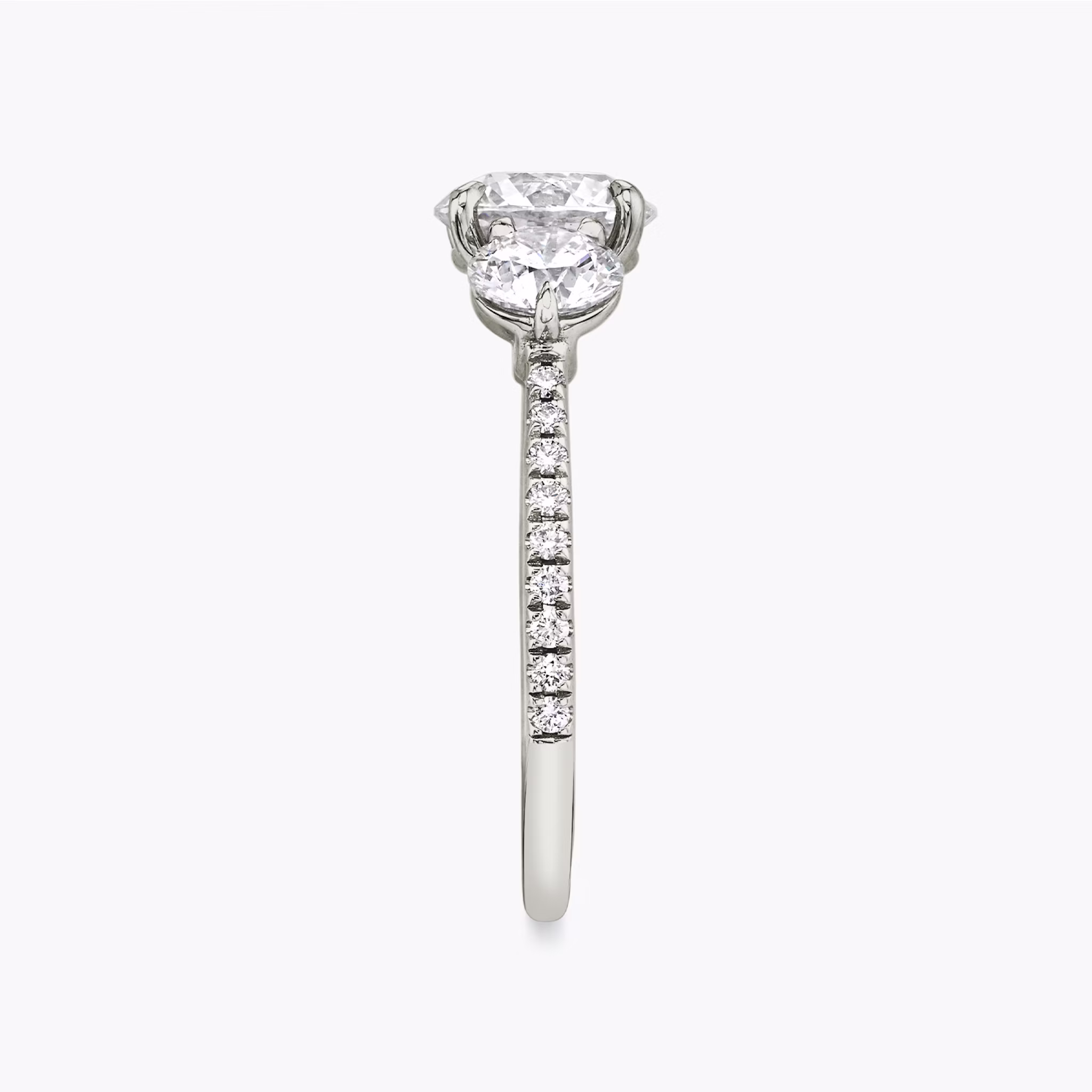 The Three Stone | Round Brilliant | 18k | White Gold | bandAccent: Pavé | caratWeight: other | sideStoneCarat: 0.50ct | sideStoneShape: Round Brilliant | diamondOrientation: vertical