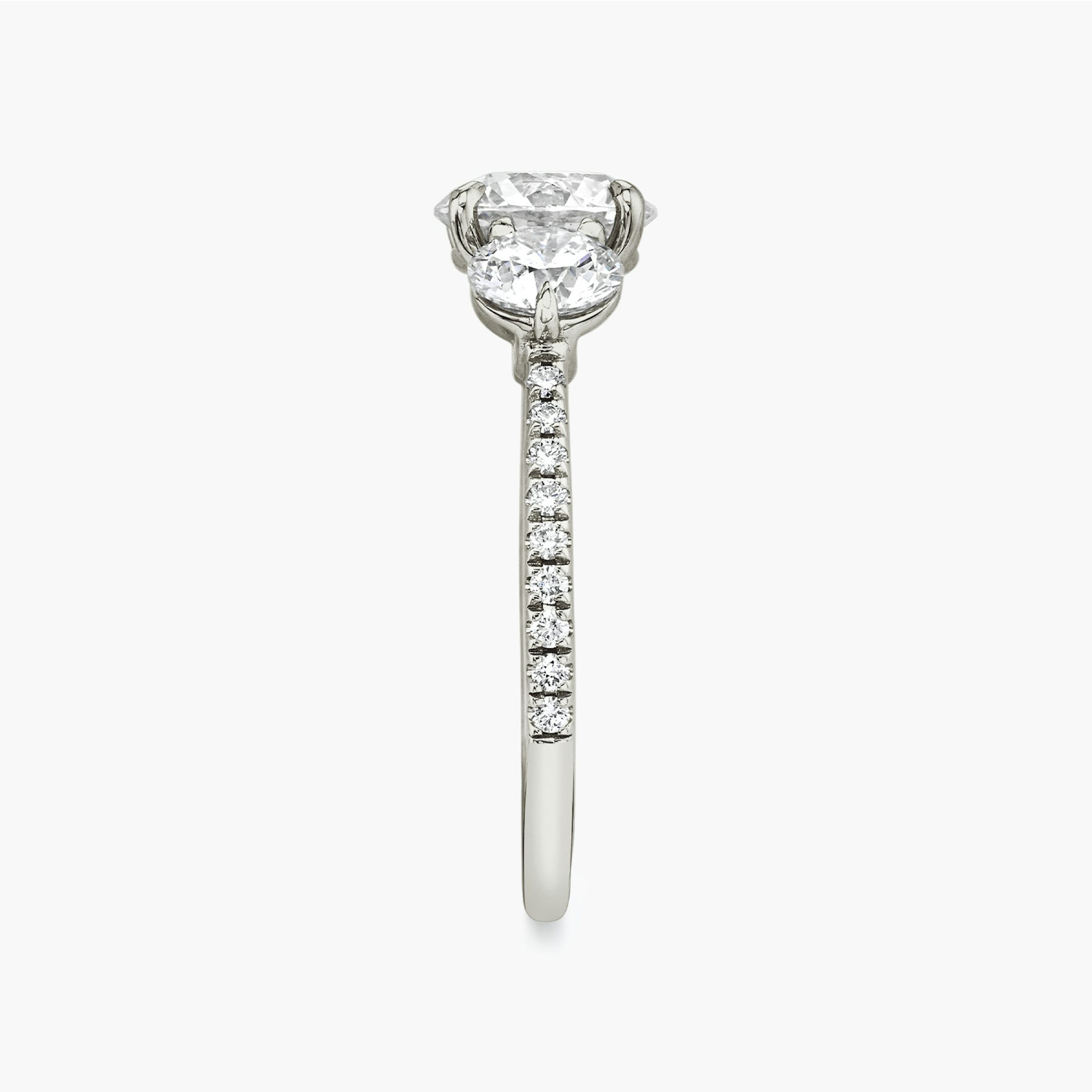 The Three Stone | Round Brilliant | 18k | White Gold | bandAccent: Pavé | caratWeight: other | sideStoneCarat: 0.50ct | sideStoneShape: Round Brilliant | diamondOrientation: vertical