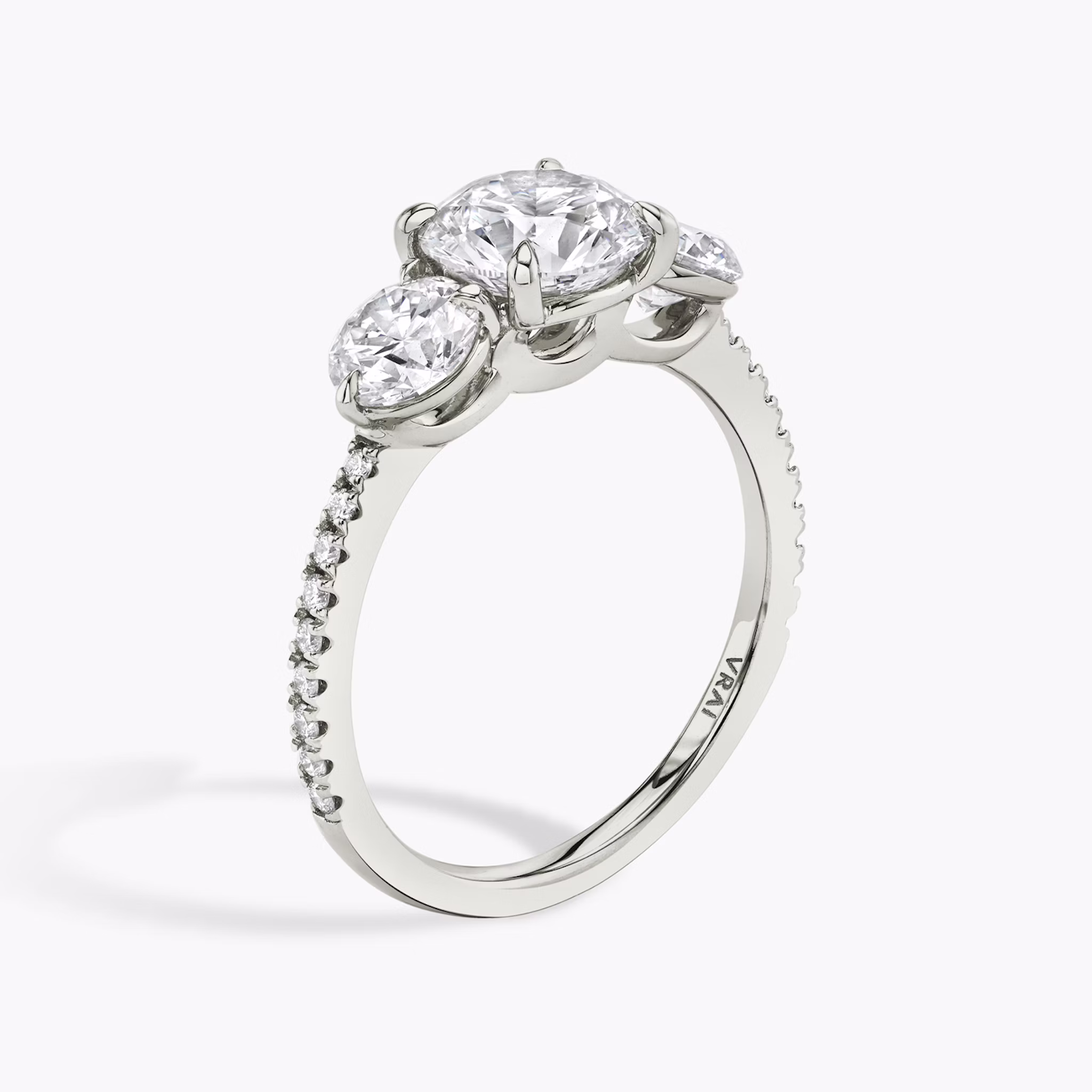 The Three Stone | Round Brilliant | Platinum | bandAccent: Pavé | caratWeight: other | sideStoneCarat: 0.50ct | sideStoneShape: Round Brilliant | diamondOrientation: vertical