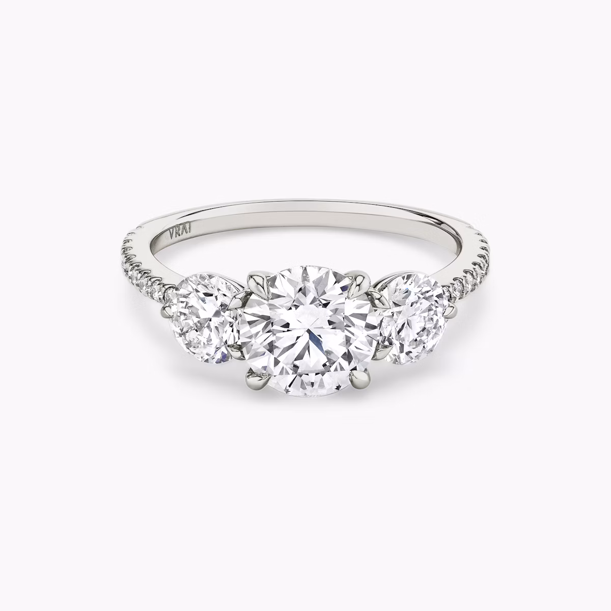The Three Stone | Round Brilliant | Platinum | bandAccent: Pavé | caratWeight: other | sideStoneCarat: 0.50ct | sideStoneShape: Round Brilliant | diamondOrientation: vertical