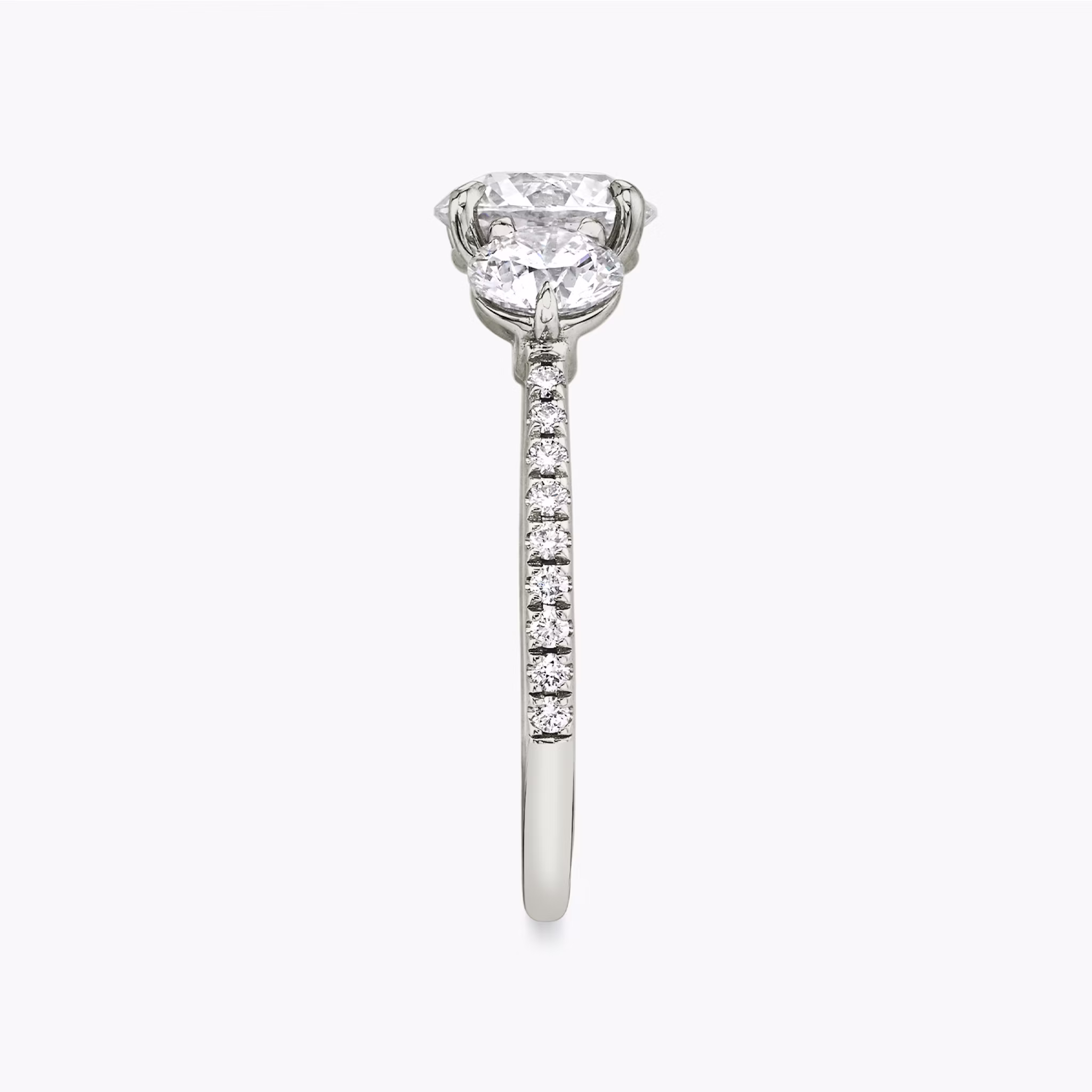 The Three Stone | Round Brilliant | Platinum | bandAccent: Pavé | caratWeight: other | sideStoneCarat: 0.50ct | sideStoneShape: Round Brilliant | diamondOrientation: vertical