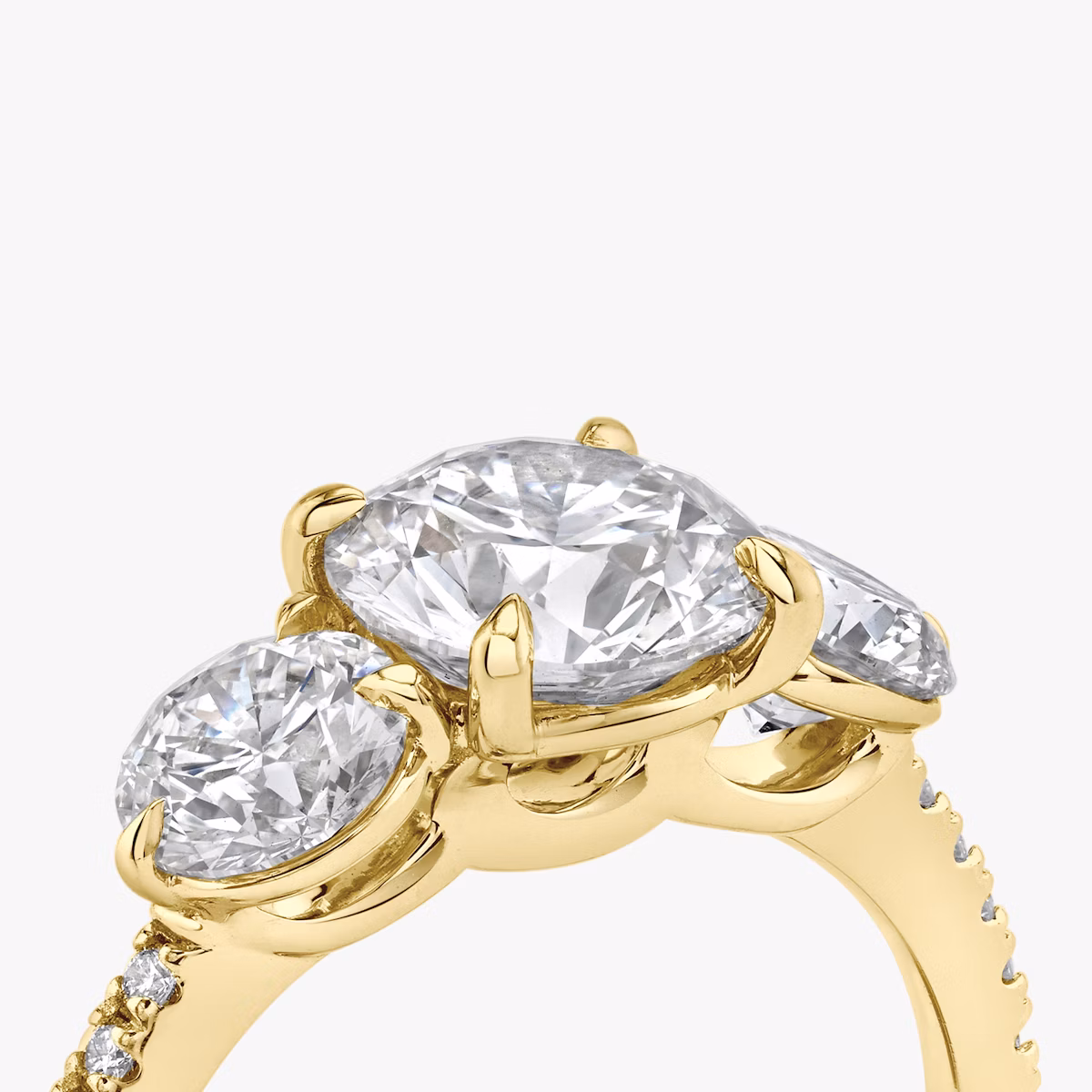 The Three Stone | Round Brilliant | 18k | Yellow Gold | bandAccent: Pavé | caratWeight: other | sideStoneCarat: 0.50ct | sideStoneShape: Round Brilliant | diamondOrientation: vertical