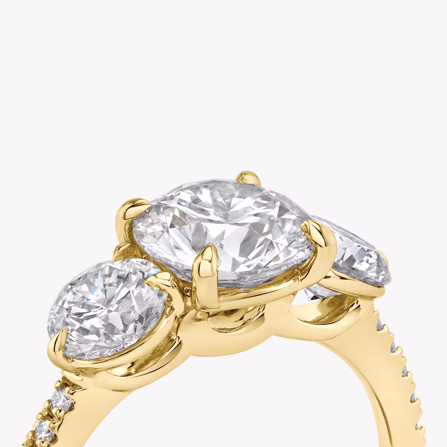 The Three Stone | Round Brilliant | 18k | Yellow Gold | bandAccent: Pavé | caratWeight: other | sideStoneCarat: 0.50ct | sideStoneShape: Round Brilliant | diamondOrientation: vertical