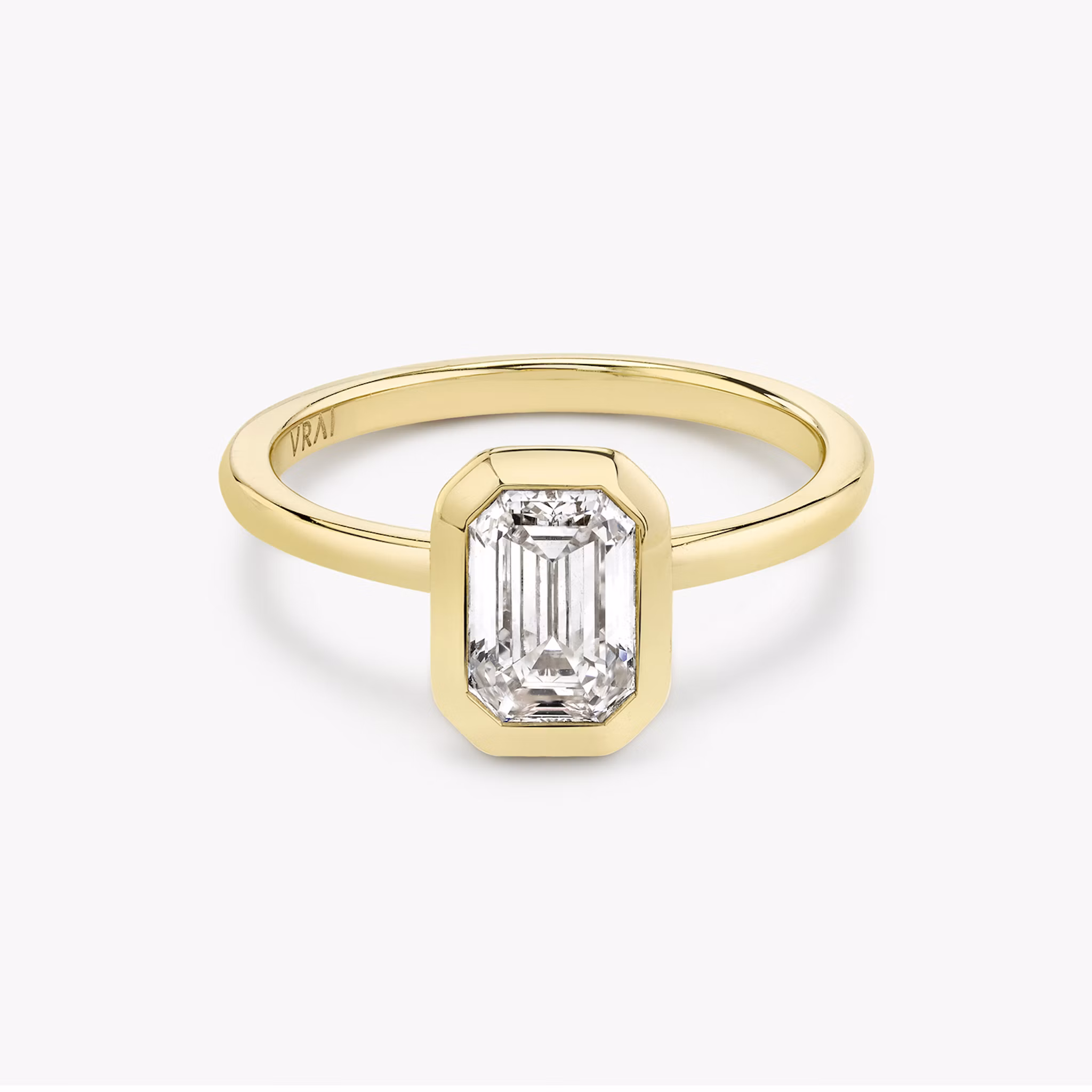 Signature bezel emerald cut engagement ring