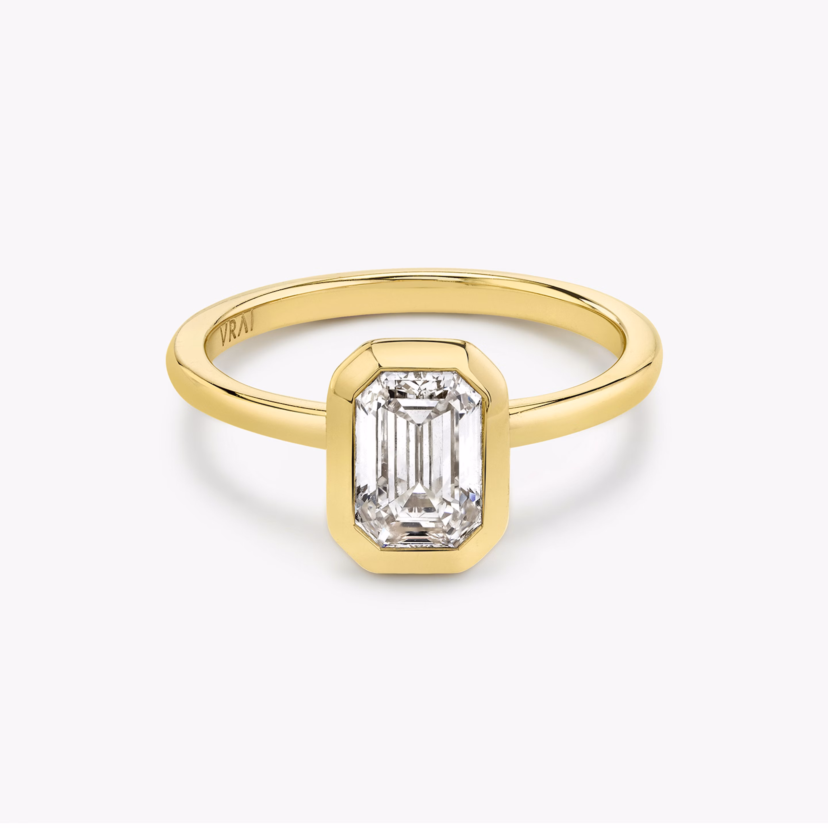 Signature bezel emerald cut engagement ring