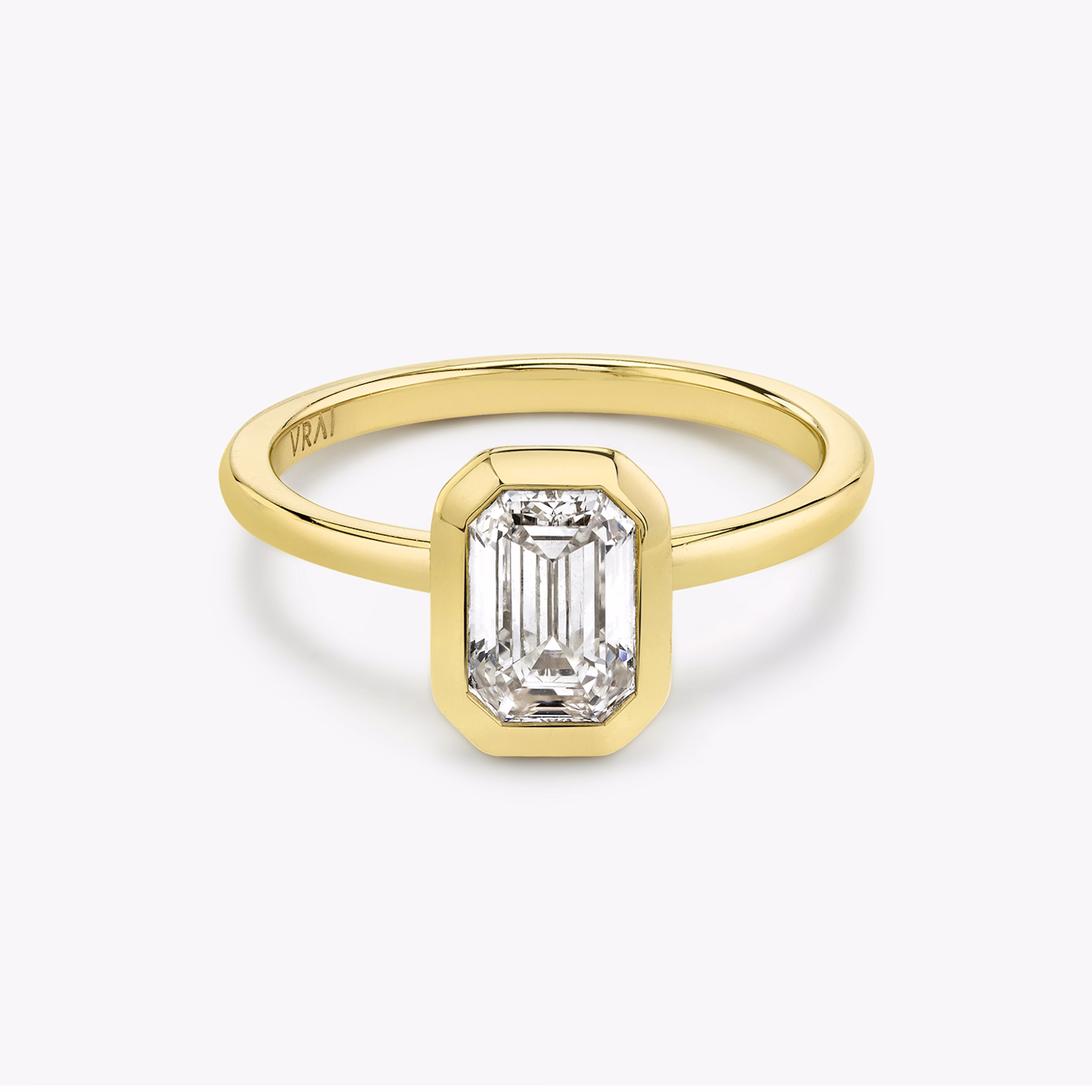 Signature bezel emerald cut engagement ring