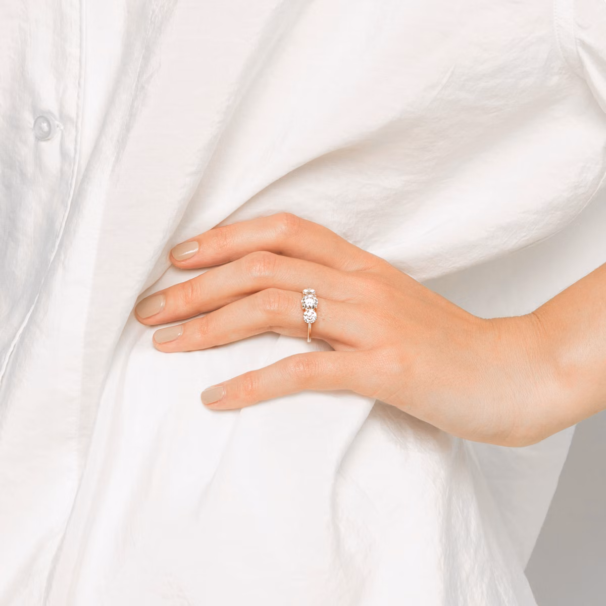 The Three Stone | Round Brilliant | Platinum | bandAccent: Plain | caratWeight: other | sideStoneCarat: 0.50ct | sideStoneShape: Round Brilliant | diamondOrientation: vertical