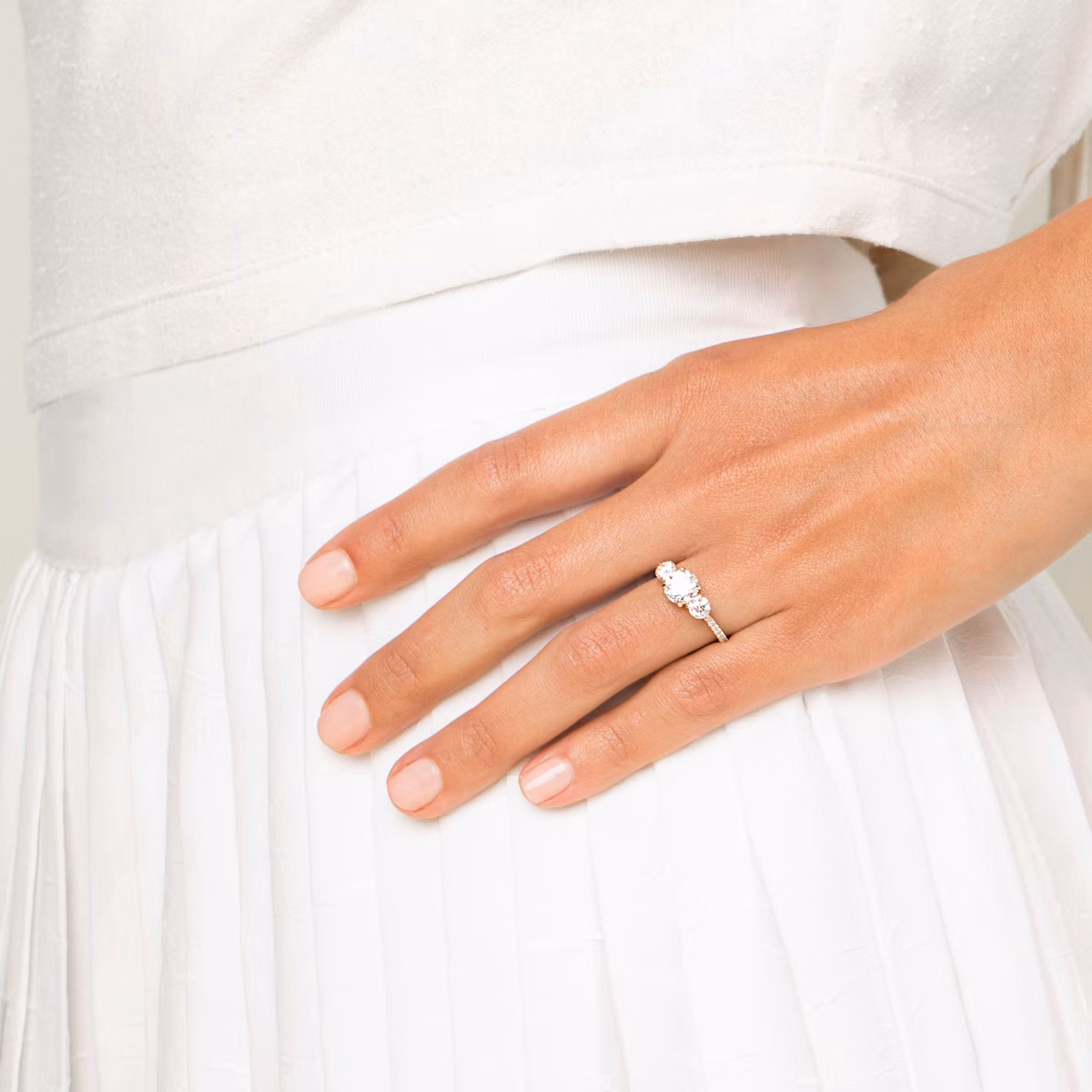 The Three Stone | Round Brilliant | Platinum | bandAccent: Pavé | caratWeight: other | sideStoneCarat: 0.25ct | sideStoneShape: Round Brilliant | diamondOrientation: vertical