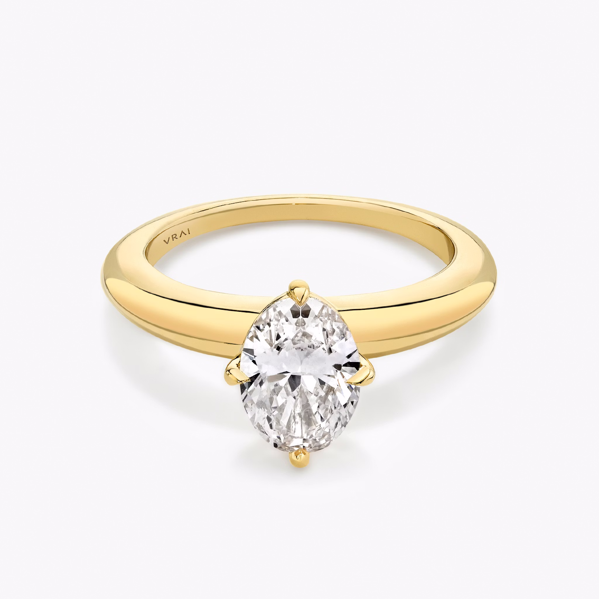 Yellow gold rounded band with an oval shaped diamond
