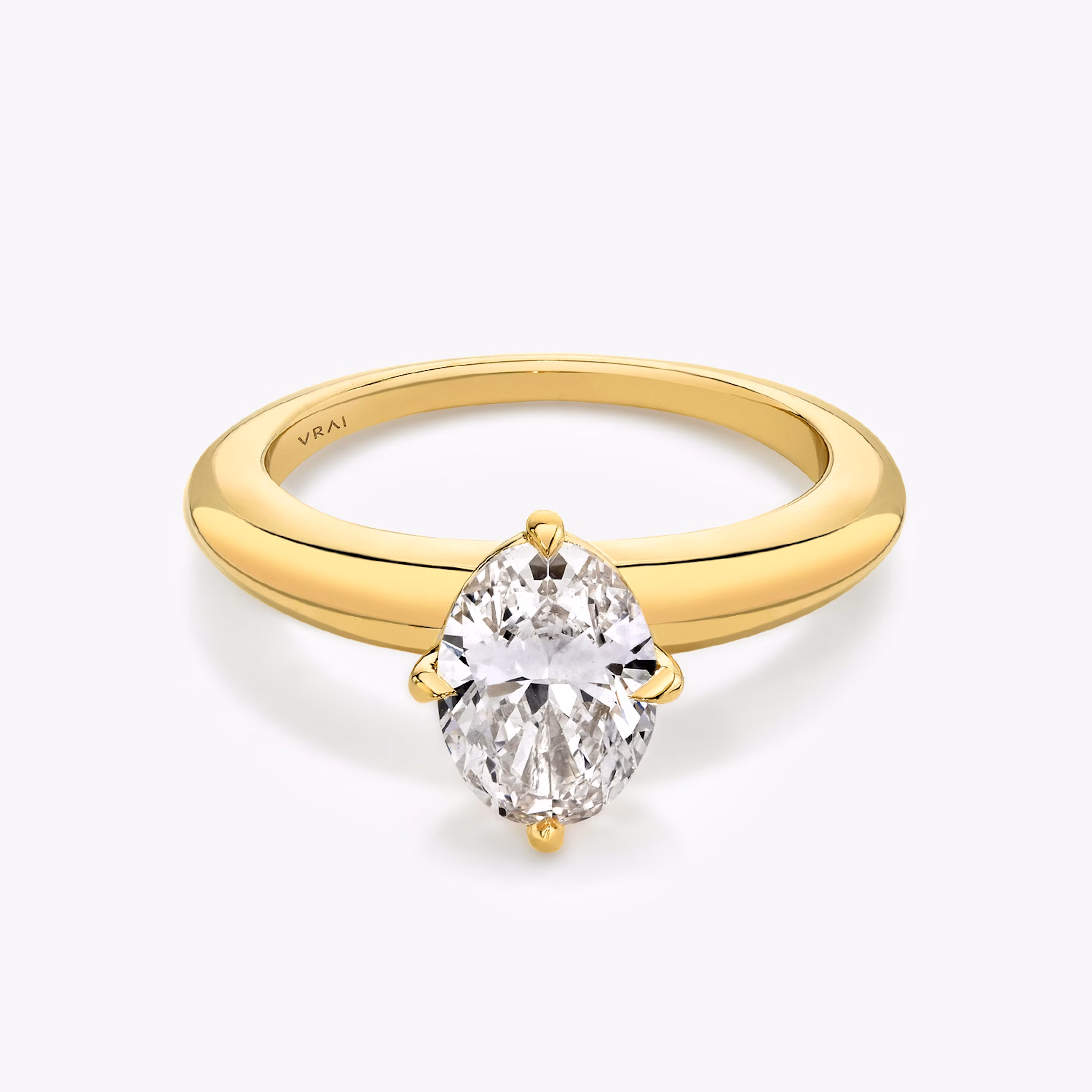 Yellow gold rounded band with an oval shaped diamond