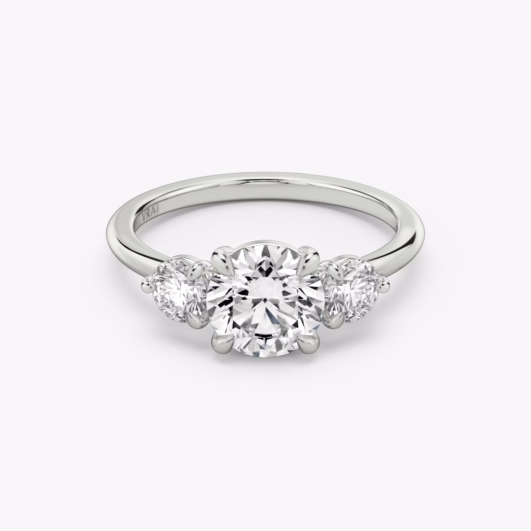 The Three Stone | Round Brilliant | 18k | White Gold | bandAccent: Plain | caratWeight: other | sideStoneCarat: 0.25ct | sideStoneShape: Round Brilliant | diamondOrientation: vertical
