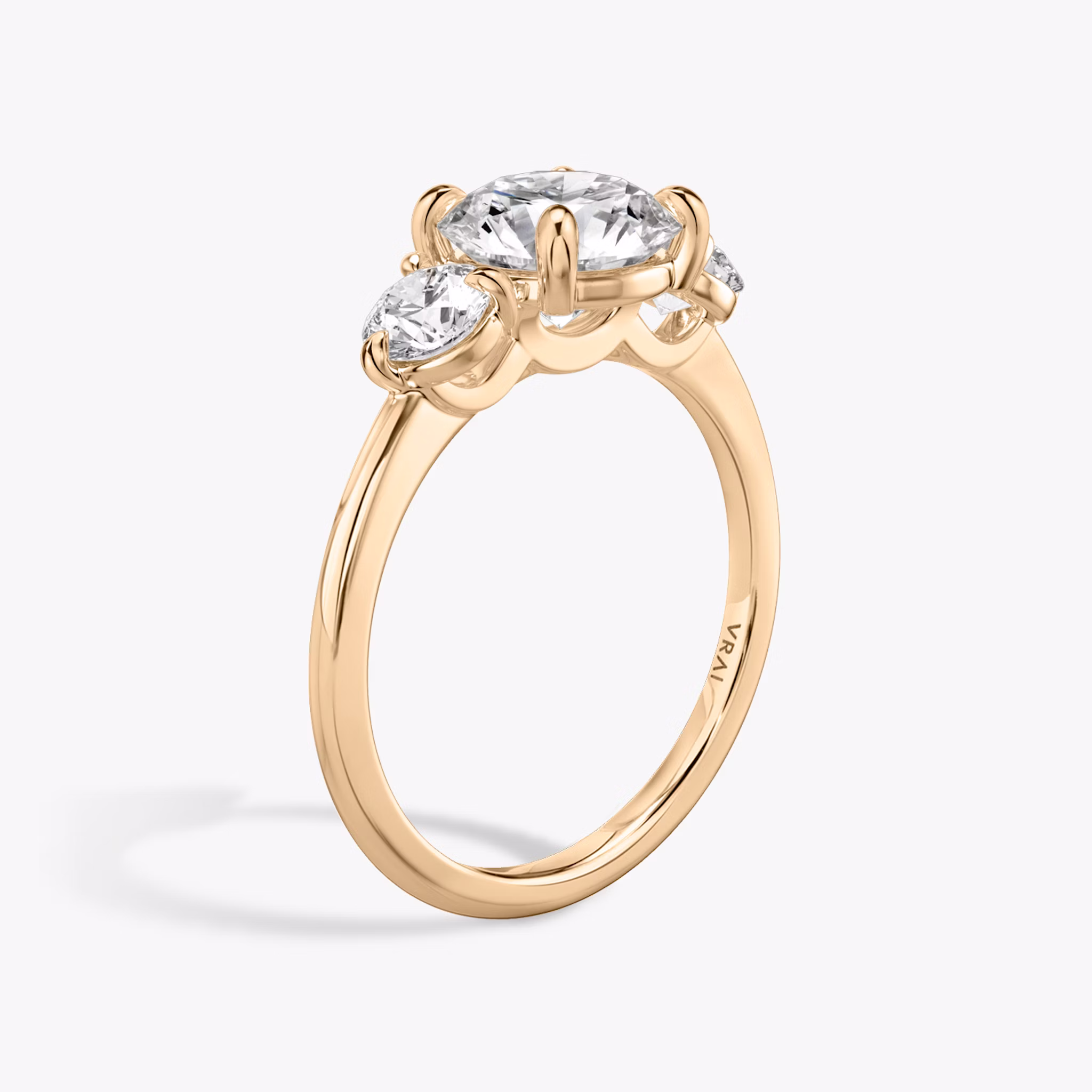 The Three Stone | Round Brilliant | 14k | Rose Gold | bandAccent: Plain | caratWeight: other | sideStoneCarat: 0.25ct | sideStoneShape: Round Brilliant | diamondOrientation: vertical