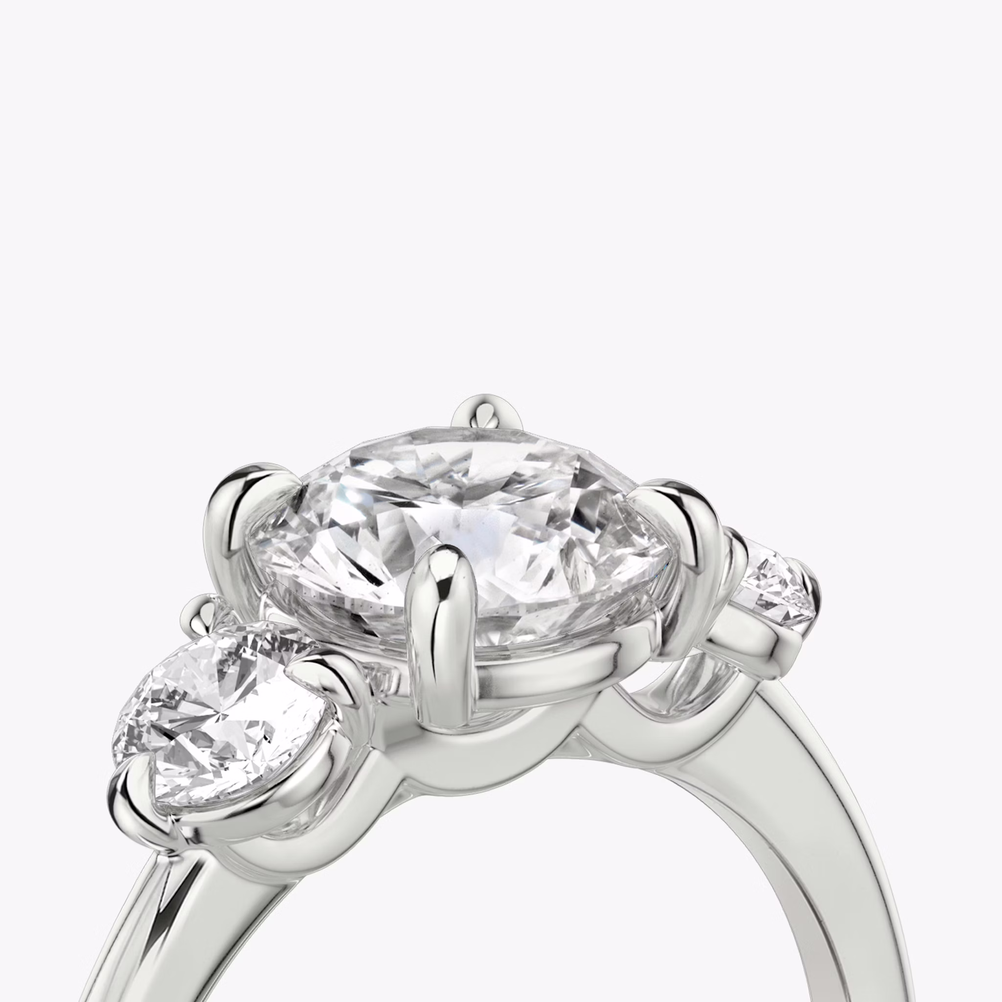 The Three Stone | Round Brilliant | 18k | White Gold | bandAccent: Plain | caratWeight: other | sideStoneCarat: 0.25ct | sideStoneShape: Round Brilliant | diamondOrientation: vertical