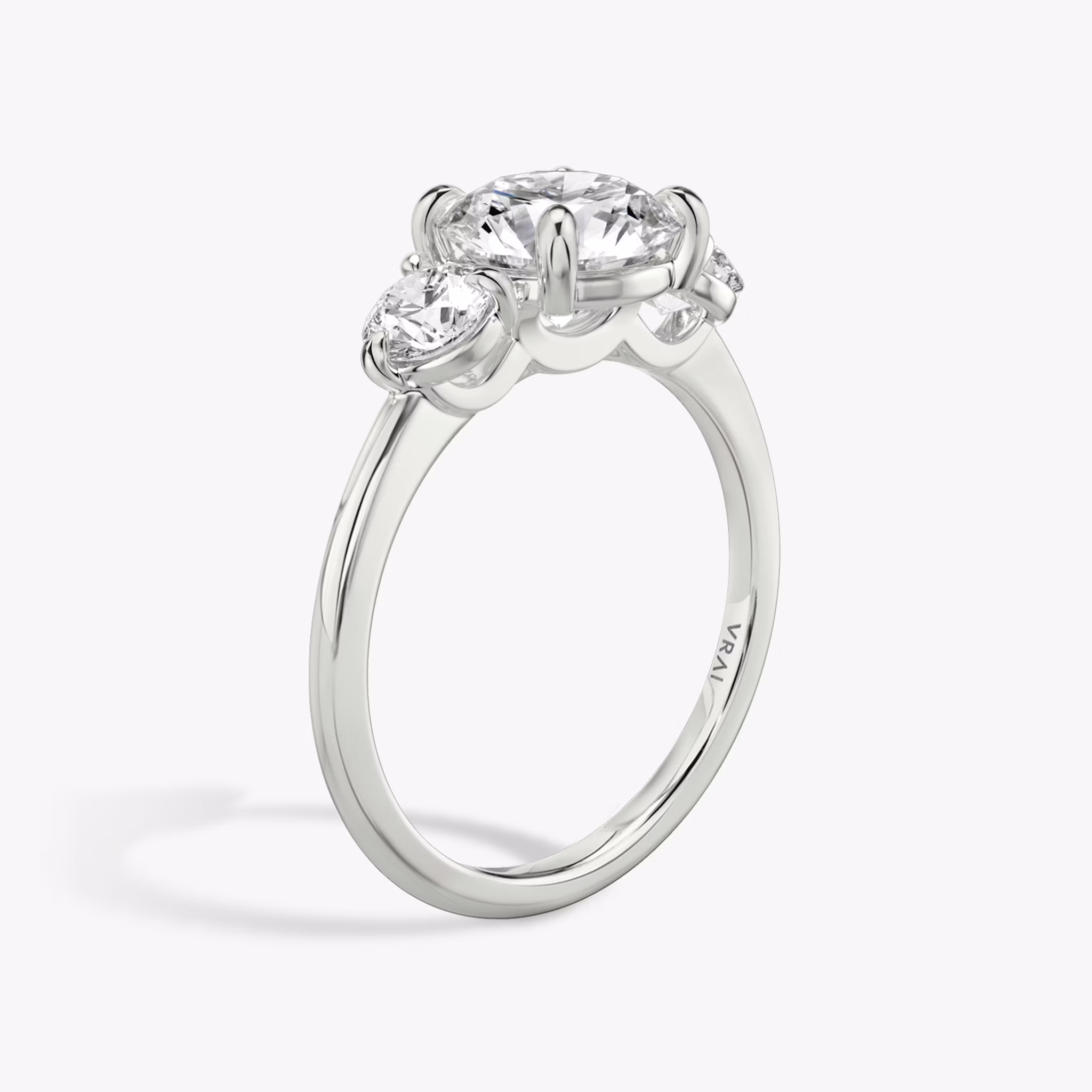 The Three Stone | Round Brilliant | 18k | White Gold | bandAccent: Plain | caratWeight: other | sideStoneCarat: 0.25ct | sideStoneShape: Round Brilliant | diamondOrientation: vertical