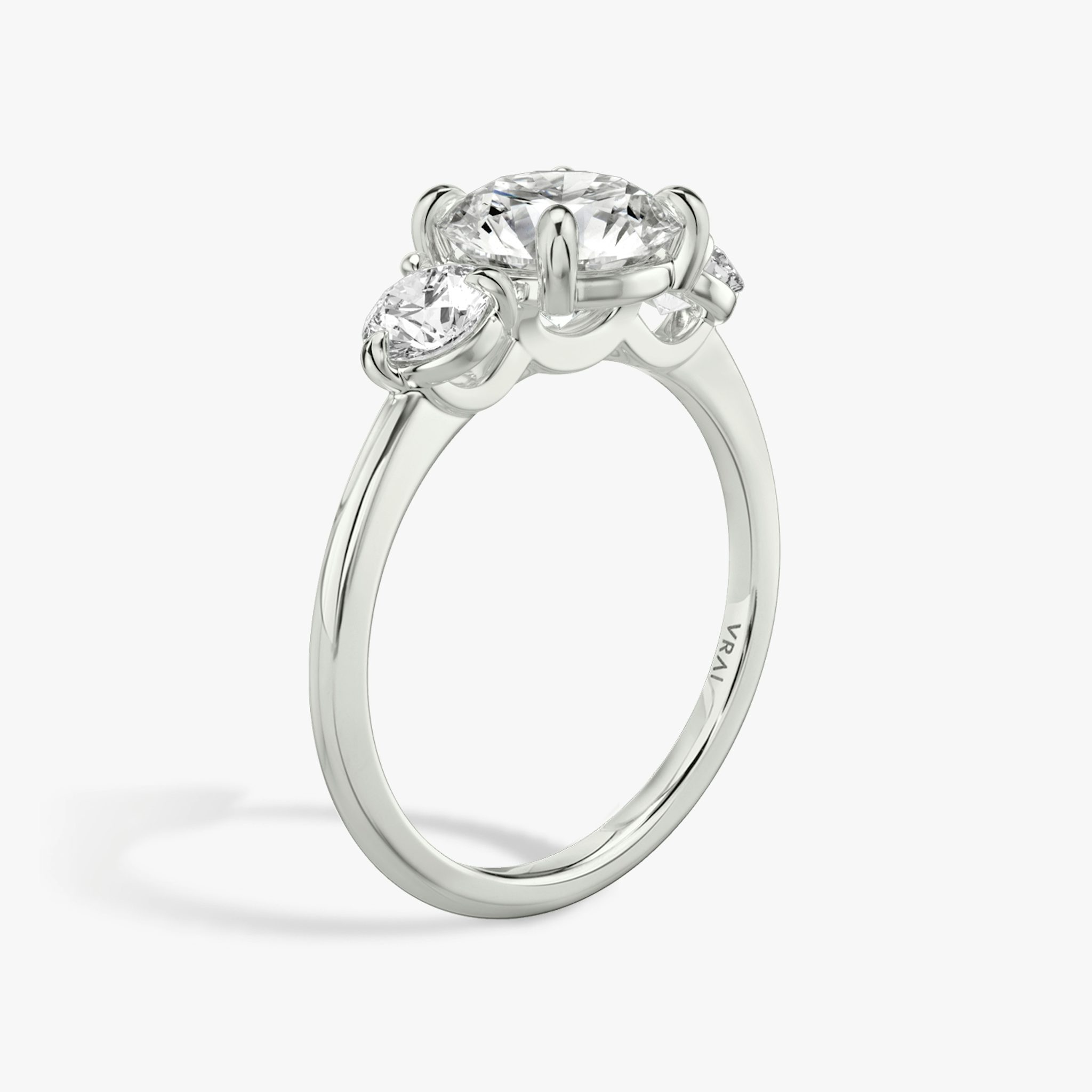 The Three Stone | Round Brilliant | 18k | White Gold | bandAccent: Plain | caratWeight: other | sideStoneCarat: 0.25ct | sideStoneShape: Round Brilliant | diamondOrientation: vertical