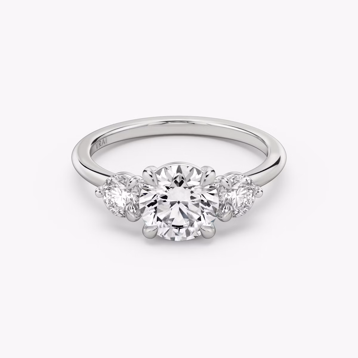 The Three Stone | Round Brilliant | Platinum | bandAccent: Plain | caratWeight: other | sideStoneCarat: 0.25ct | sideStoneShape: Round Brilliant | diamondOrientation: vertical