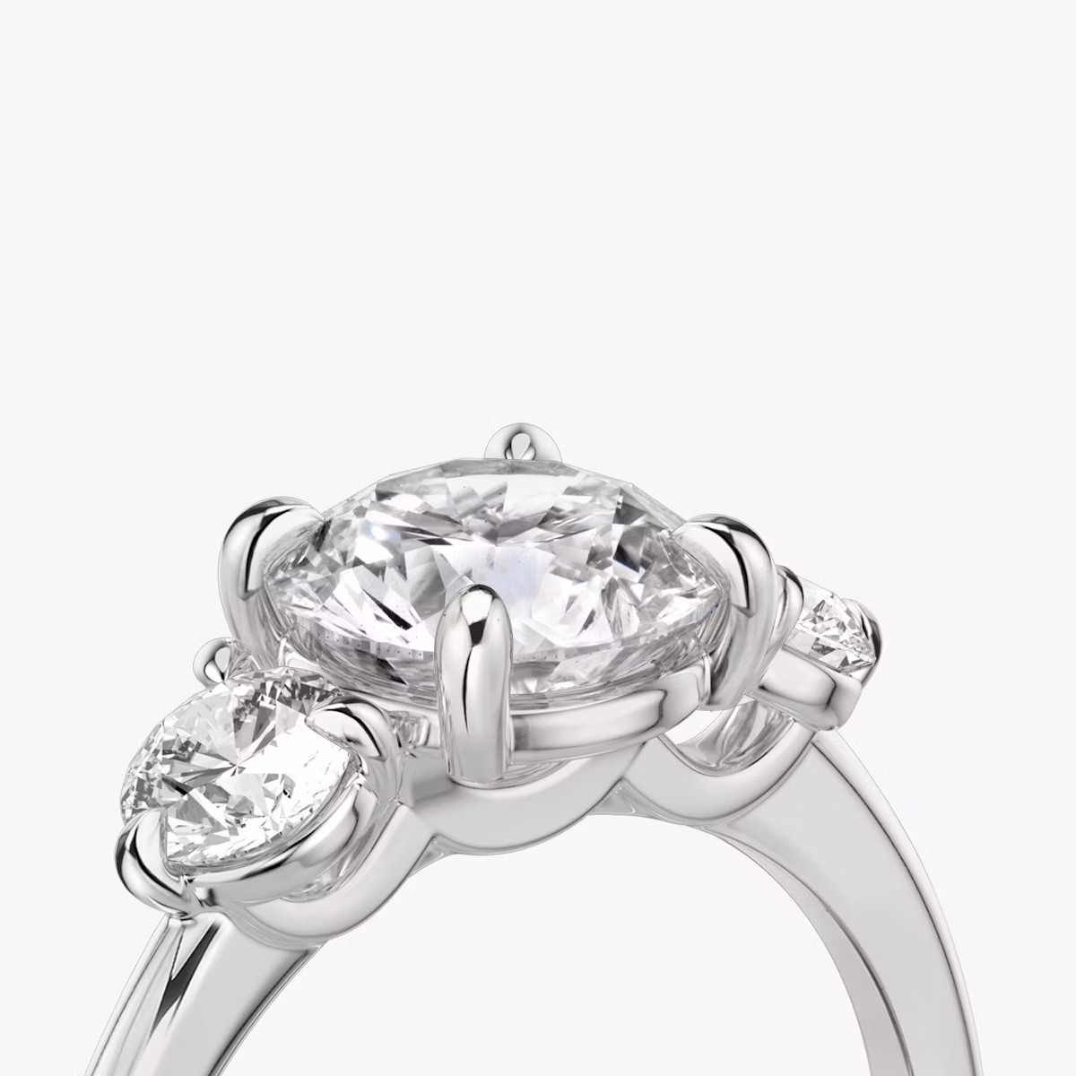The Three Stone | Round Brilliant | Platinum | bandAccent: Plain | caratWeight: other | sideStoneCarat: 0.25ct | sideStoneShape: Round Brilliant | diamondOrientation: vertical