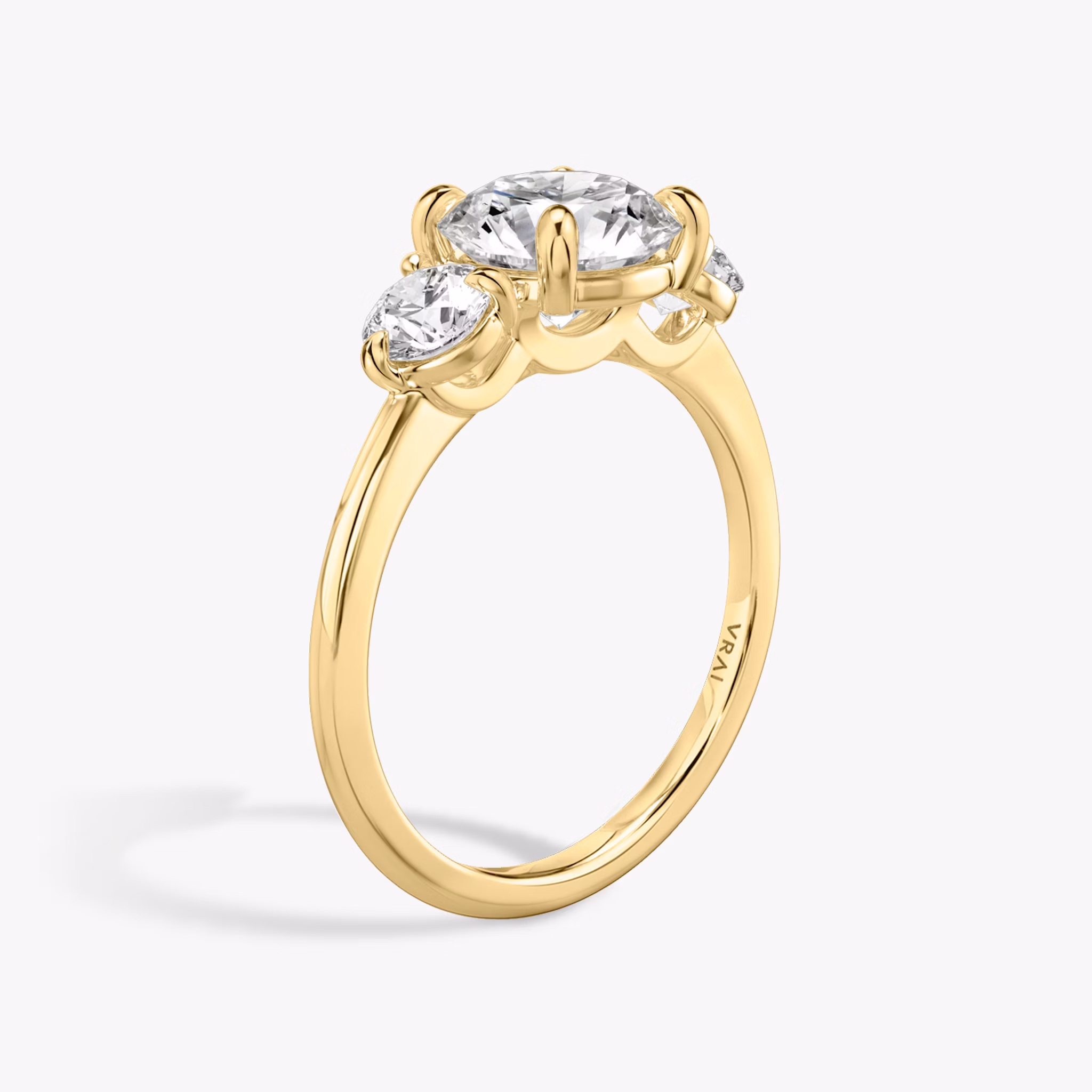 The Three Stone | Round Brilliant | 18k | Yellow Gold | bandAccent: Plain | caratWeight: other | sideStoneCarat: 0.25ct | sideStoneShape: Round Brilliant | diamondOrientation: vertical