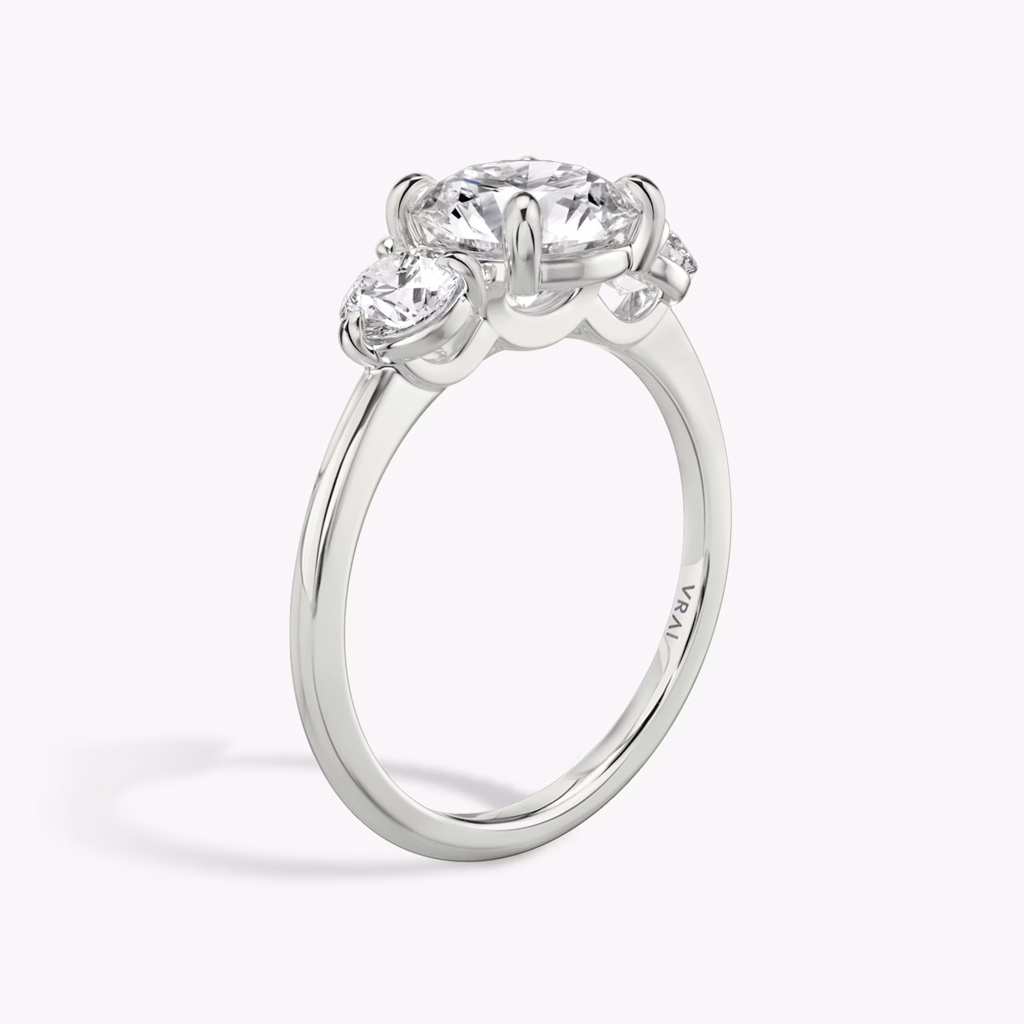 The Three Stone | Round Brilliant | Platinum | bandAccent: Plain | caratWeight: other | sideStoneCarat: 0.25ct | sideStoneShape: Round Brilliant | diamondOrientation: vertical