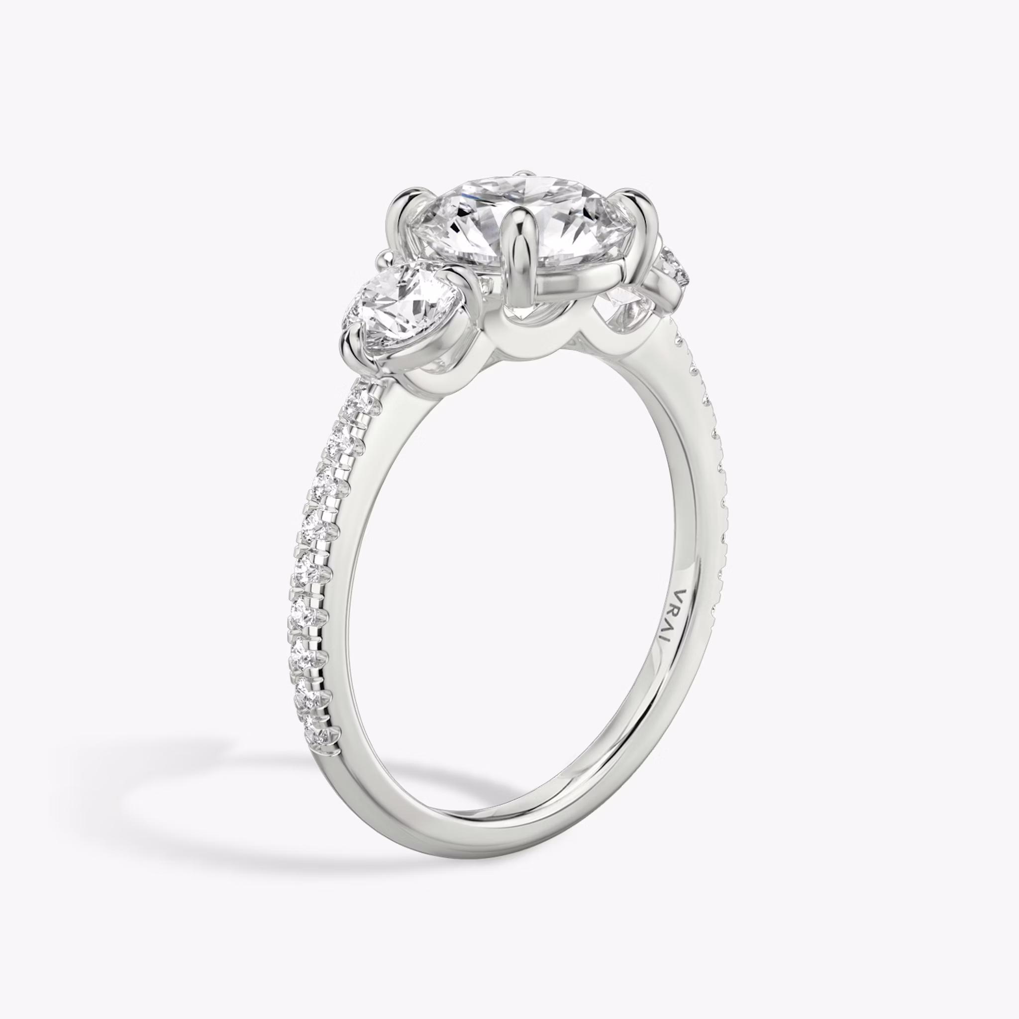 The Three Stone | Round Brilliant | Platinum | bandAccent: Pavé | caratWeight: other | sideStoneCarat: 0.25ct | sideStoneShape: Round Brilliant | diamondOrientation: vertical