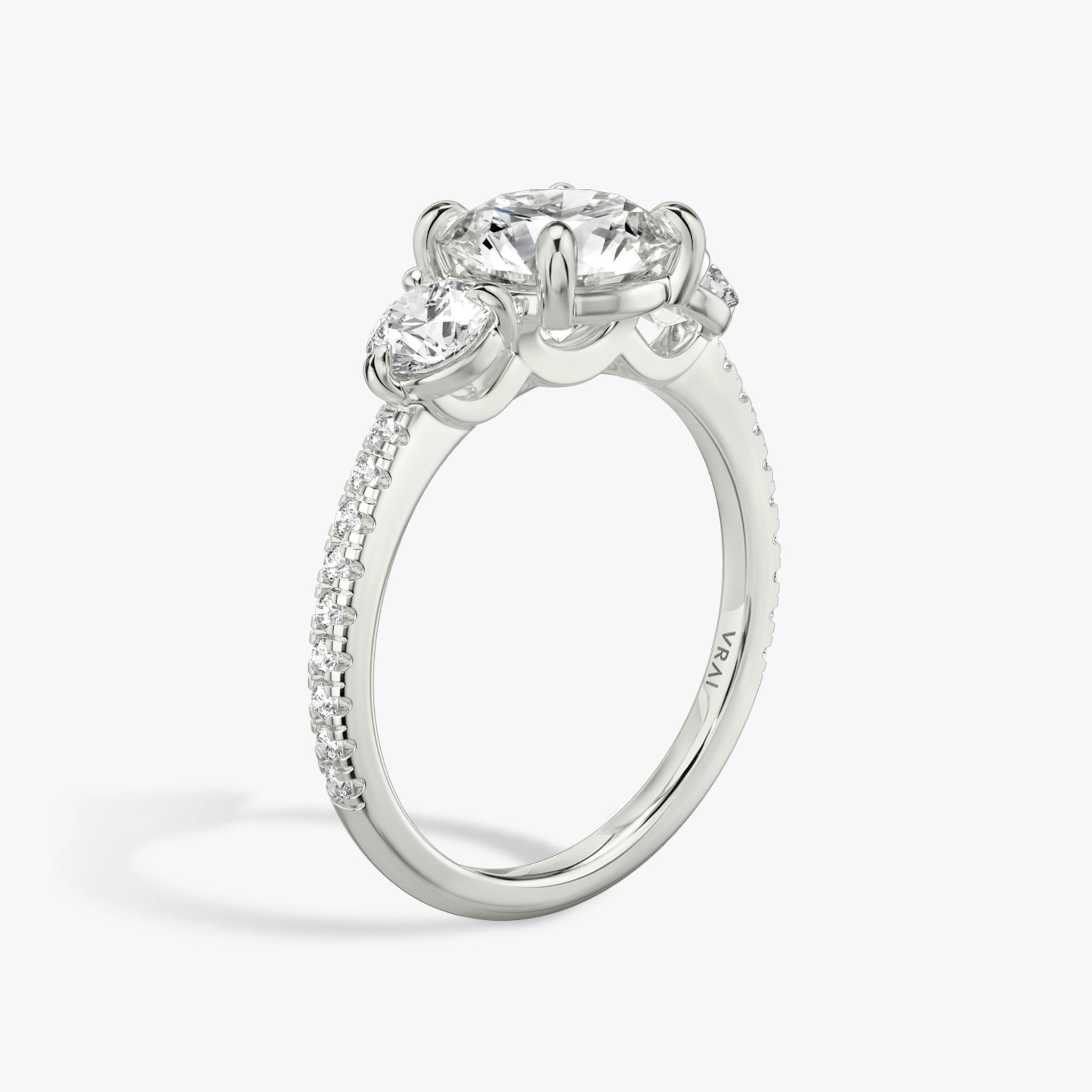 The Three Stone | Round Brilliant | Platinum | bandAccent: Pavé | caratWeight: other | sideStoneCarat: 0.25ct | sideStoneShape: Round Brilliant | diamondOrientation: vertical