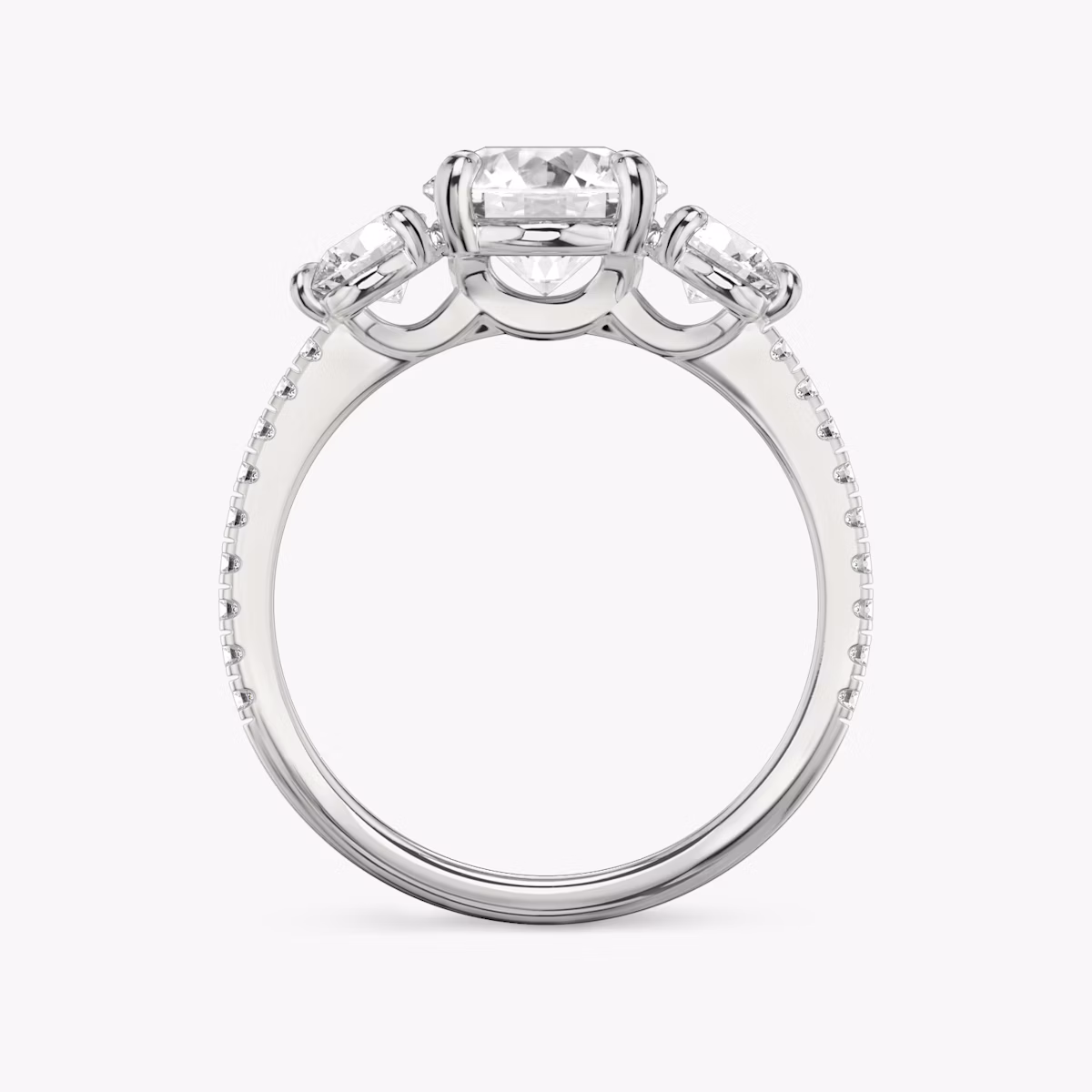The Three Stone | Round Brilliant | Platinum | bandAccent: Pavé | caratWeight: other | sideStoneCarat: 0.25ct | sideStoneShape: Round Brilliant | diamondOrientation: vertical