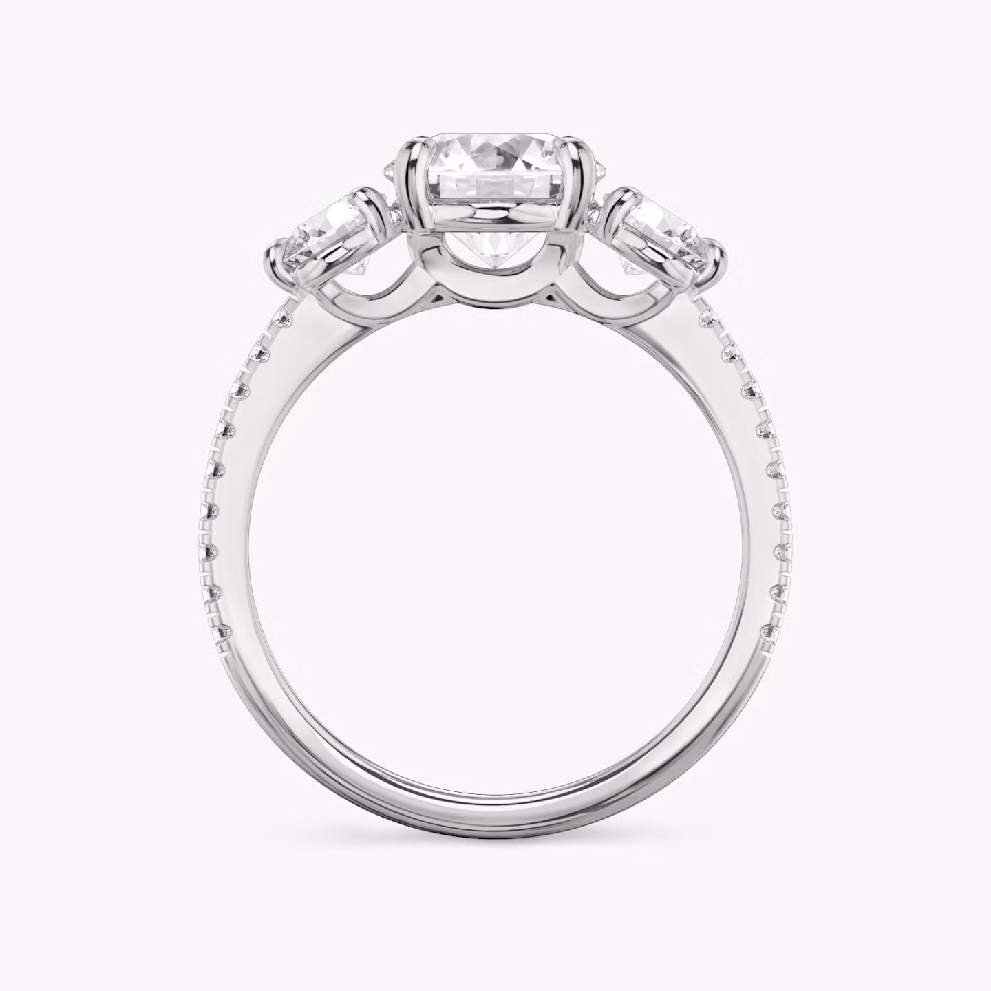 The Three Stone | Round Brilliant | Platinum | bandAccent: Pavé | caratWeight: other | sideStoneCarat: 0.25ct | sideStoneShape: Round Brilliant | diamondOrientation: vertical