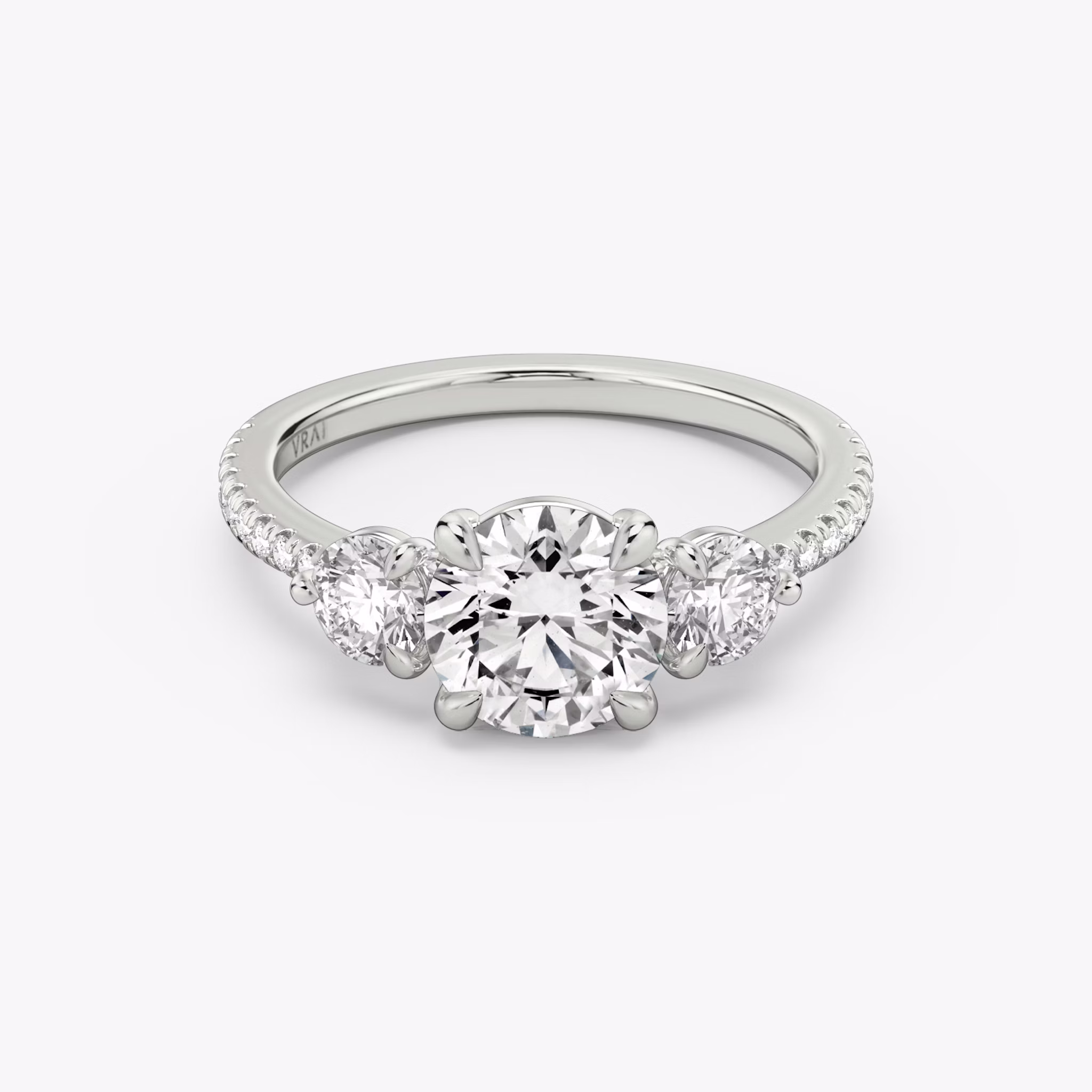The Three Stone | Round Brilliant | Platinum | bandAccent: Pavé | caratWeight: other | sideStoneCarat: 0.25ct | sideStoneShape: Round Brilliant | diamondOrientation: vertical