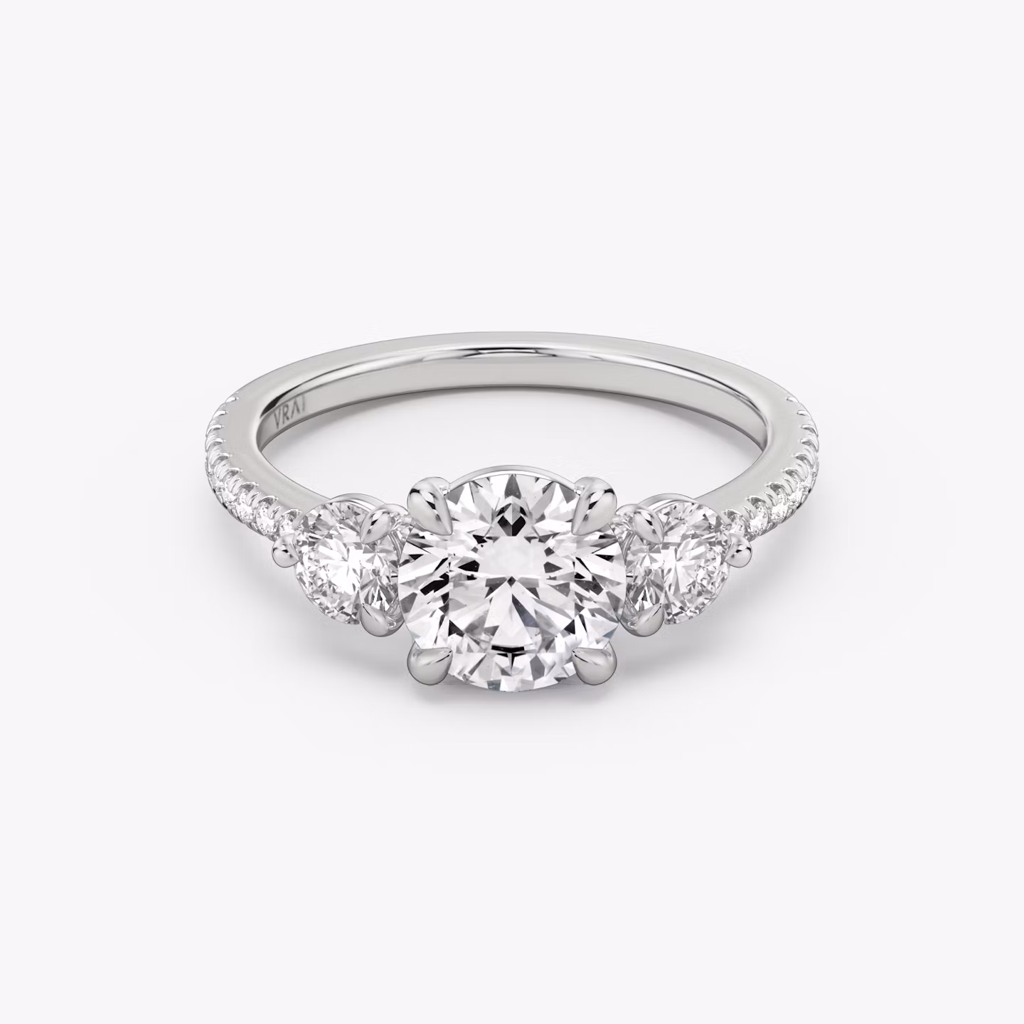 The Three Stone | Round Brilliant | Platinum | bandAccent: Pavé | caratWeight: other | sideStoneCarat: 0.25ct | sideStoneShape: Round Brilliant | diamondOrientation: vertical