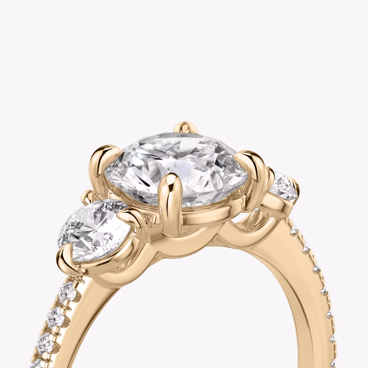 The Three Stone | Round Brilliant | 14k | Rose Gold | bandAccent: Pavé | caratWeight: other | sideStoneCarat: 0.25ct | sideStoneShape: Round Brilliant | diamondOrientation: vertical