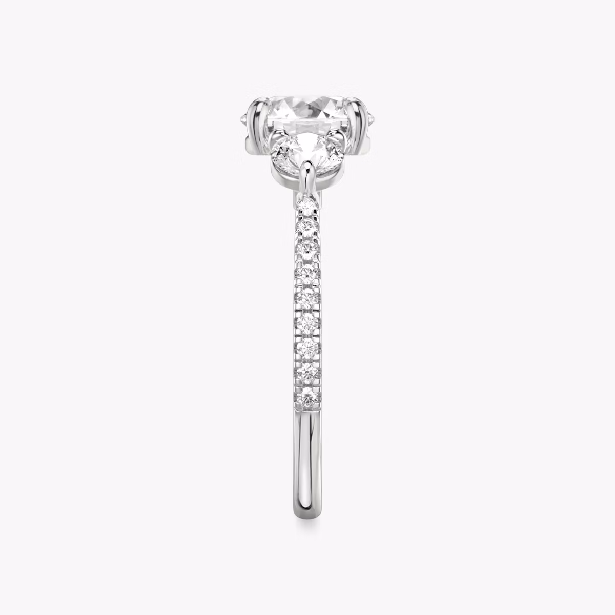 The Three Stone | Round Brilliant | Platinum | bandAccent: Pavé | caratWeight: other | sideStoneCarat: 0.25ct | sideStoneShape: Round Brilliant | diamondOrientation: vertical