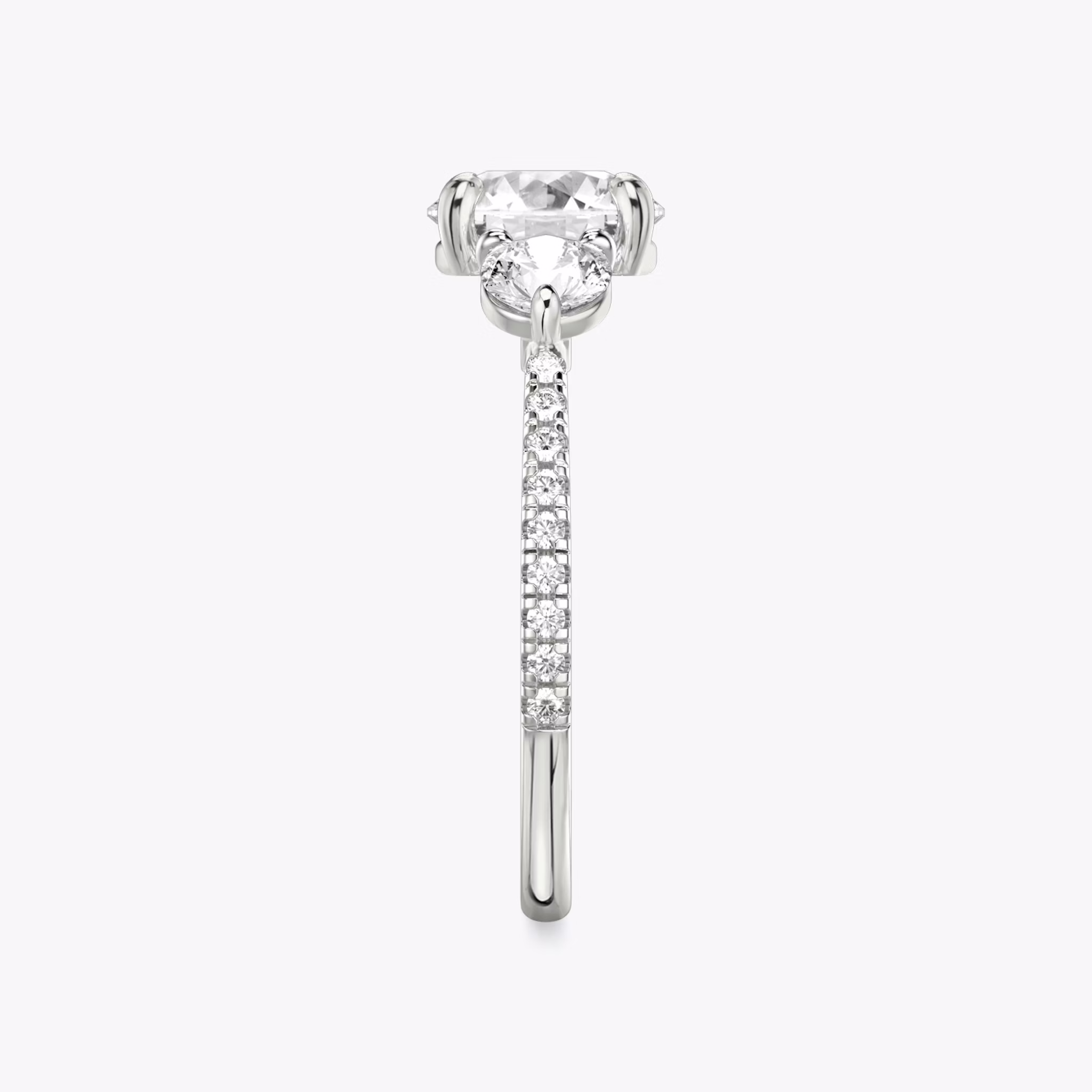 The Three Stone | Round Brilliant | Platinum | bandAccent: Pavé | caratWeight: other | sideStoneCarat: 0.25ct | sideStoneShape: Round Brilliant | diamondOrientation: vertical