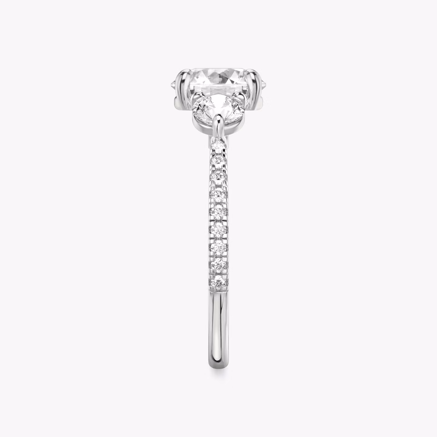 The Three Stone | Round Brilliant | Platinum | bandAccent: Pavé | caratWeight: other | sideStoneCarat: 0.25ct | sideStoneShape: Round Brilliant | diamondOrientation: vertical