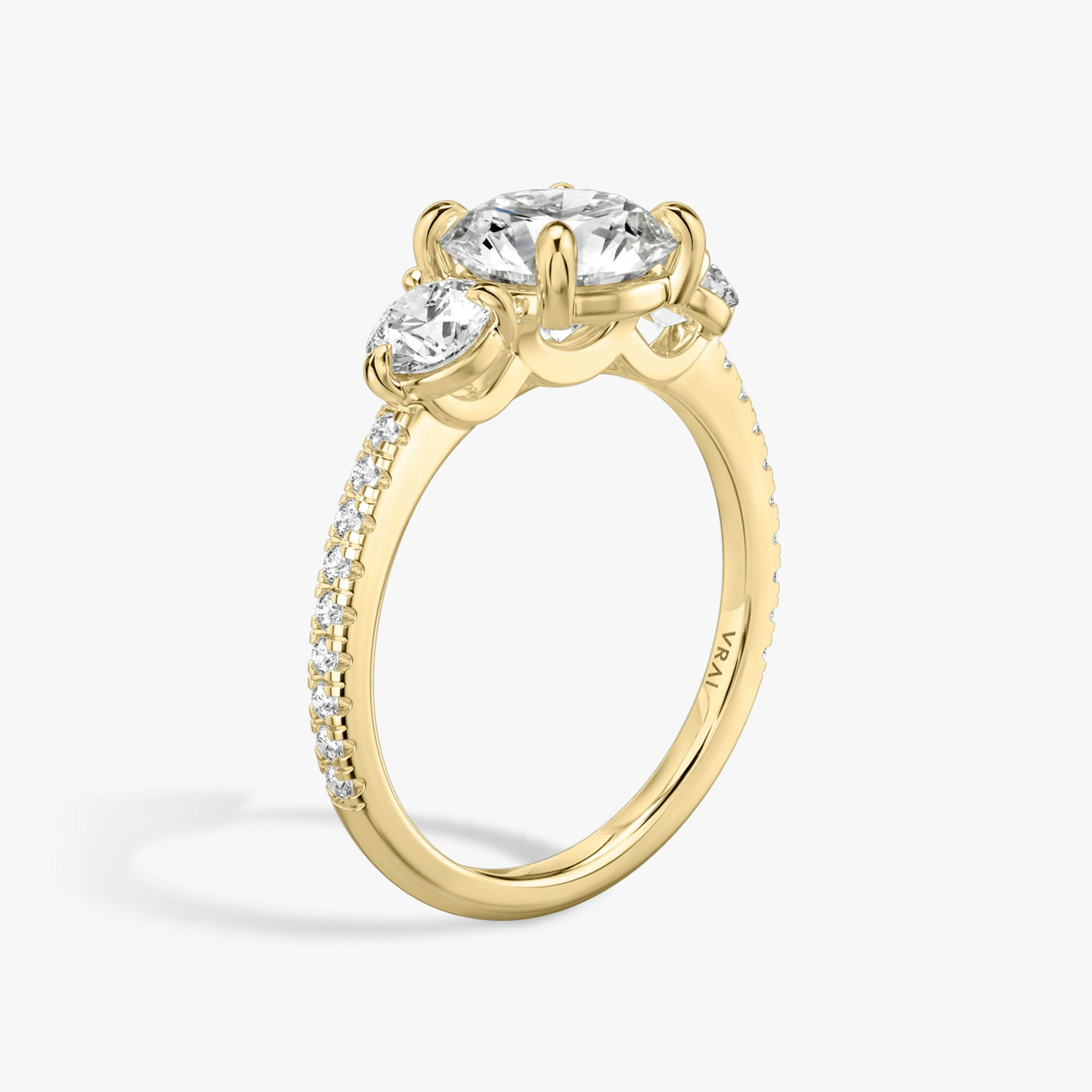 The Three Stone | Round Brilliant | 18k | Yellow Gold | bandAccent: Pavé | caratWeight: other | sideStoneCarat: 0.25ct | sideStoneShape: Round Brilliant | diamondOrientation: vertical
